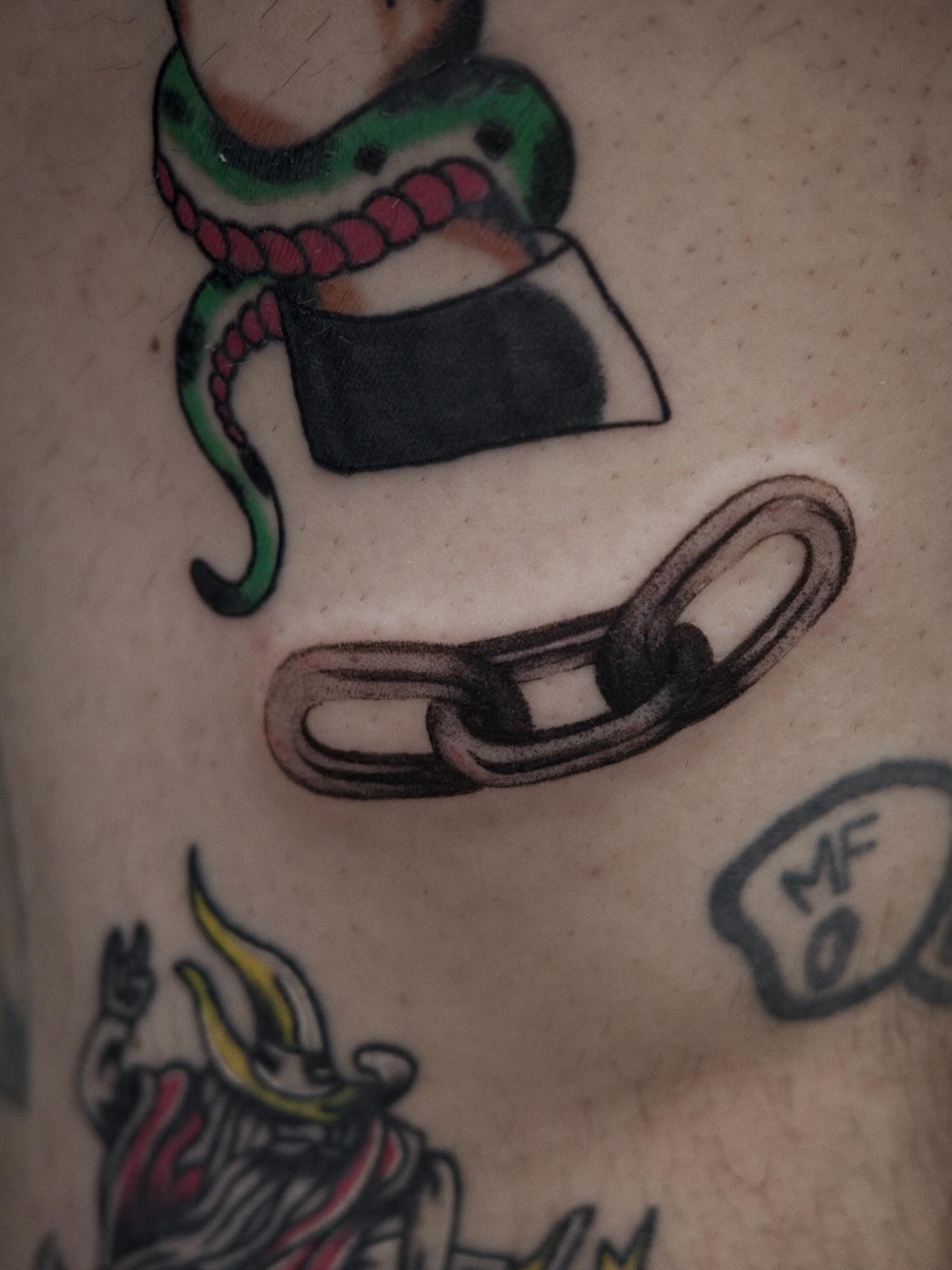 Snake and chain American traditional tattoo on the torso by It’s ya girl, KB