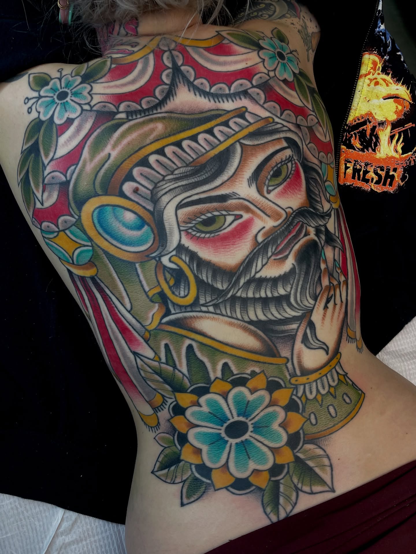 Japanese mask American traditional tattoo on the ribs by Josh Johns