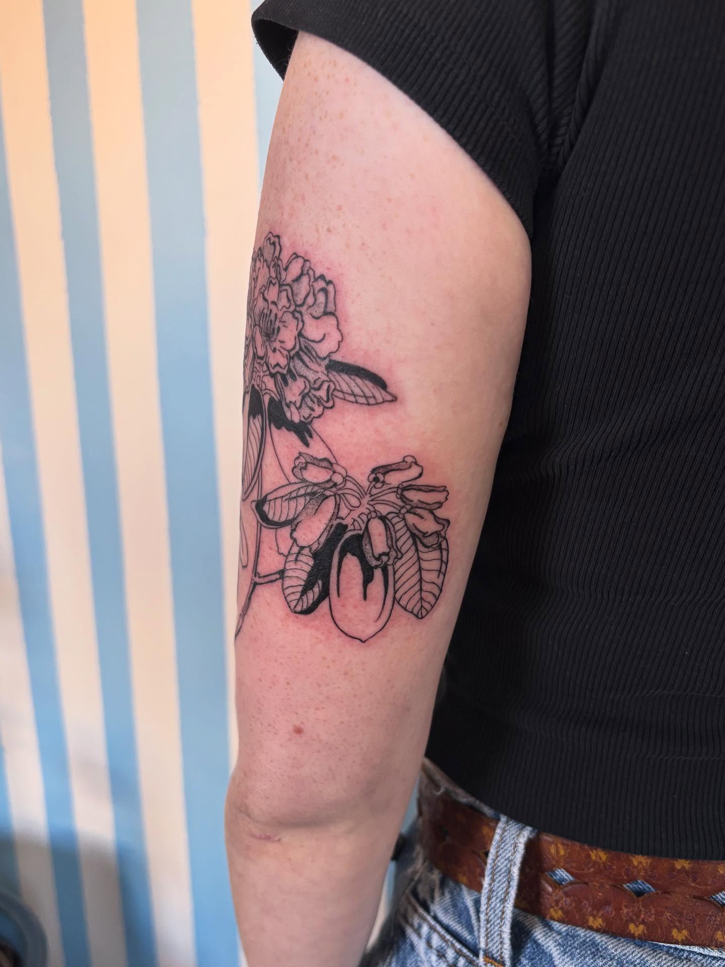 Floral arrangement black and grey tattoo on the forearm by Ashley Ellerman