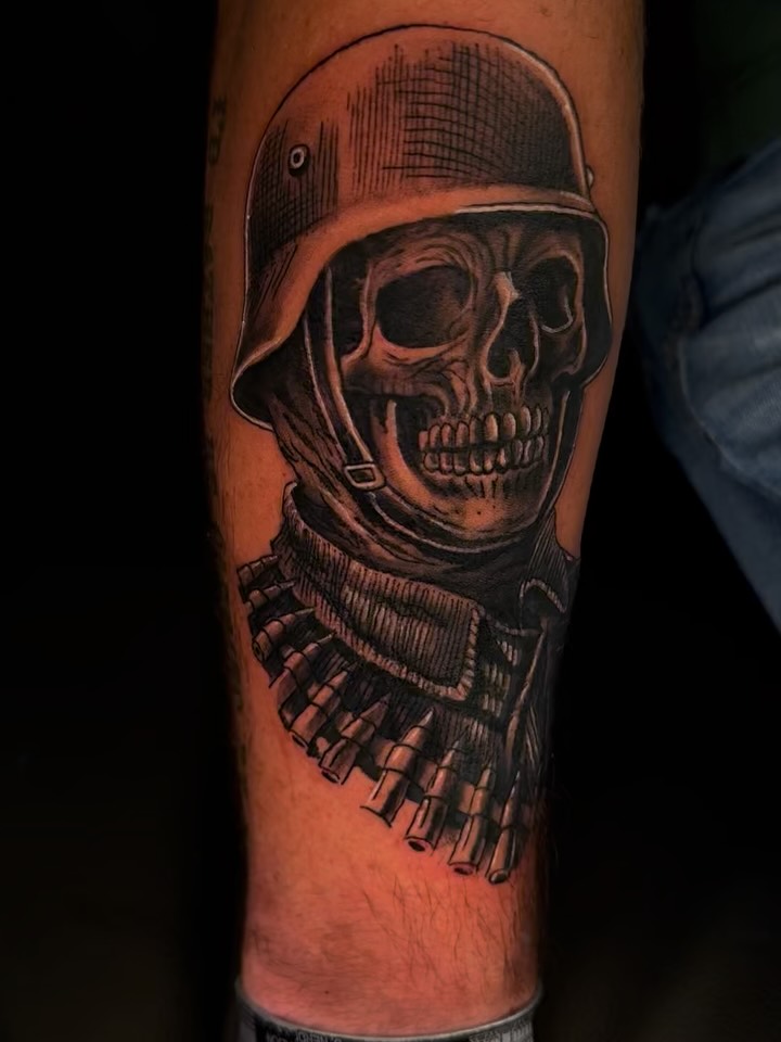 Skull wearing helmet realism tattoo on the forearm by Therapy ink