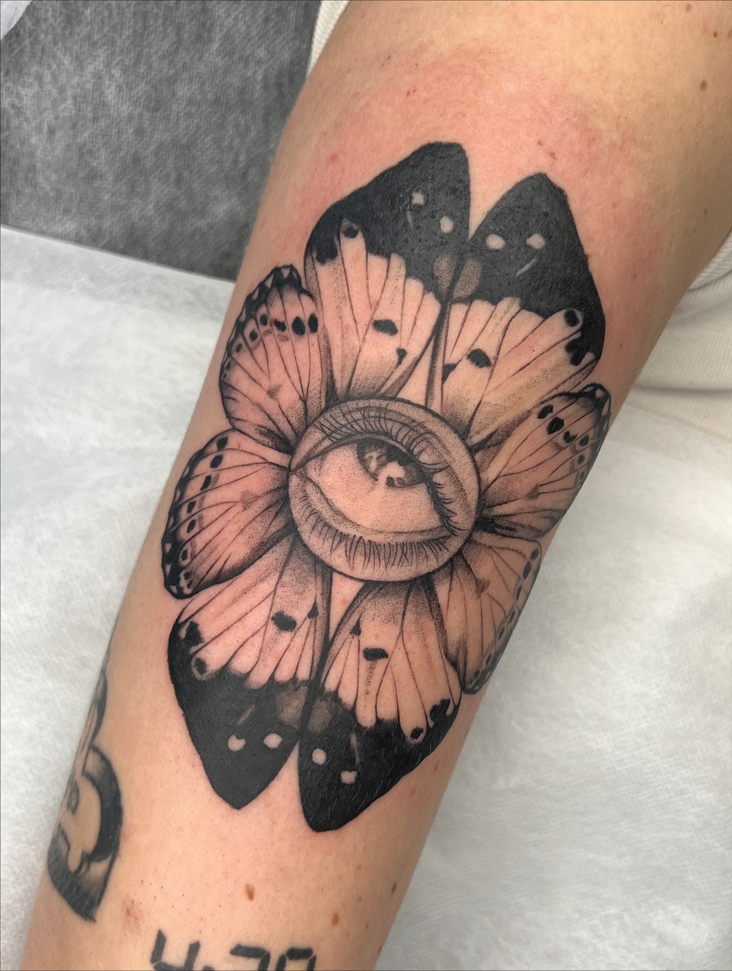 Eye and butterfly realism tattoo on the forearm by Red