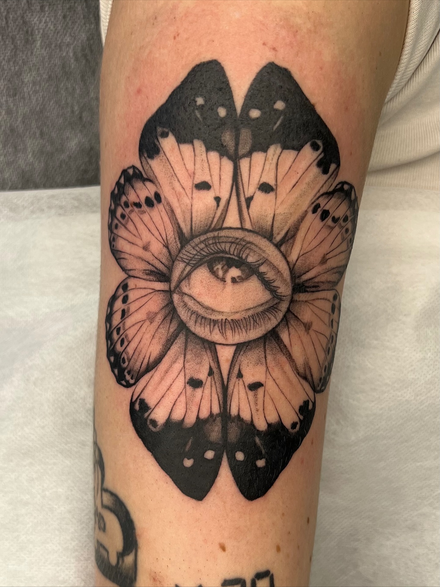 Eye and butterfly realism tattoo on the forearm by Red