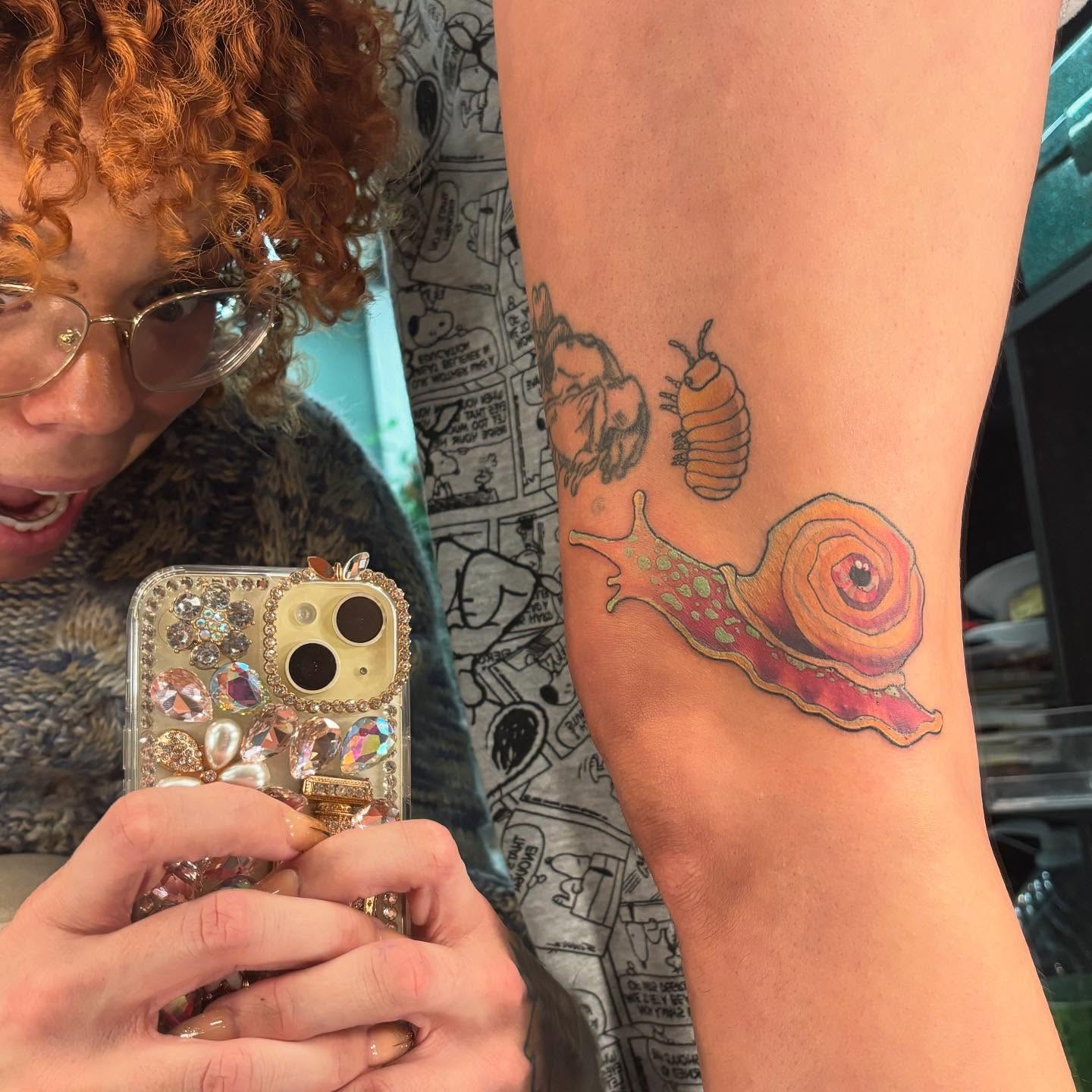 Snail realism tattoo on the forearm by Rachel Foster