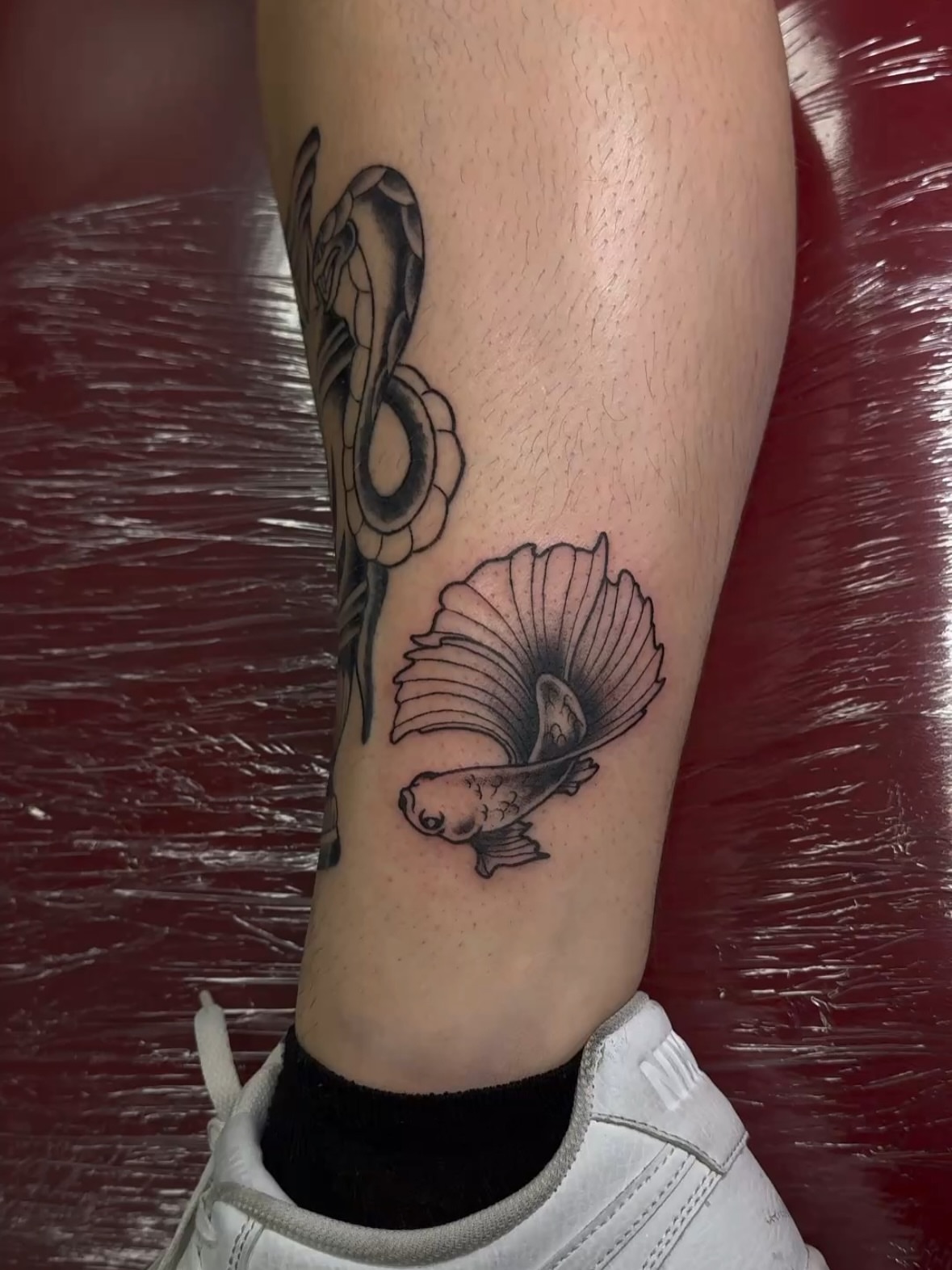 Snake and fish black and grey tattoo on the forearm by πππͺ‘