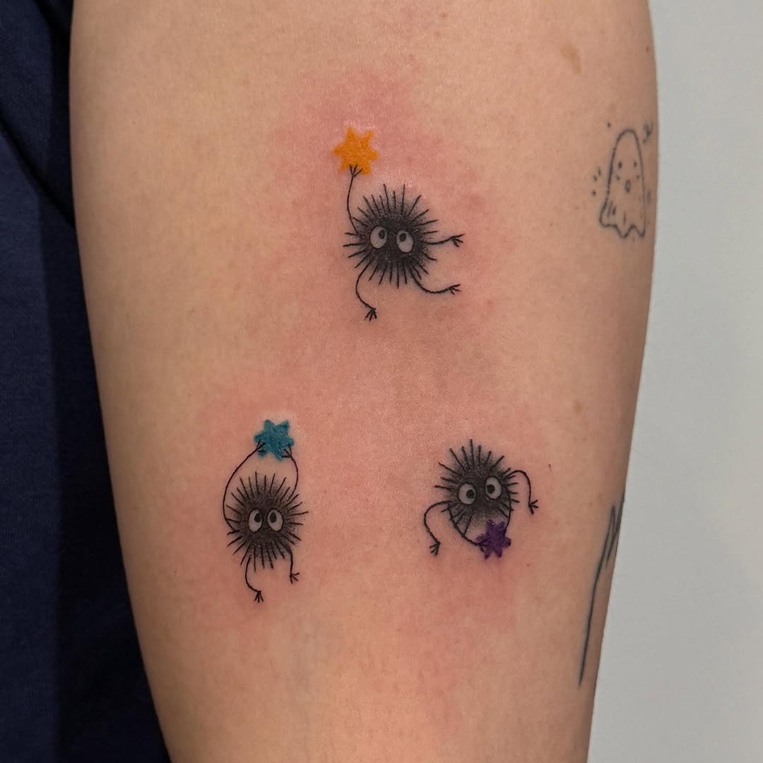 Susuwatari characters with stars new school tattoo on the forearm by Kirsten