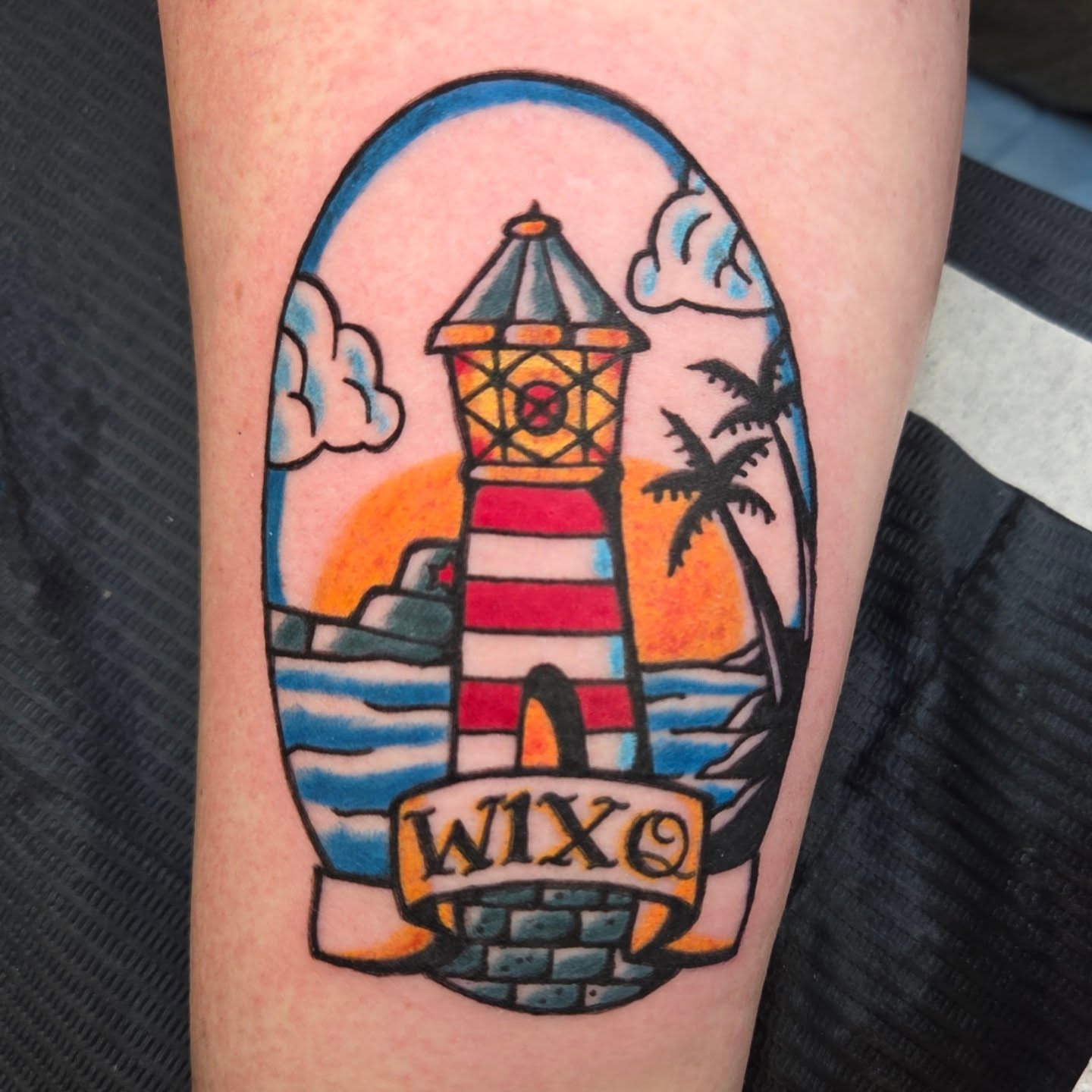 Lighthouse American traditional tattoo on the forearm by Chaz Escobar