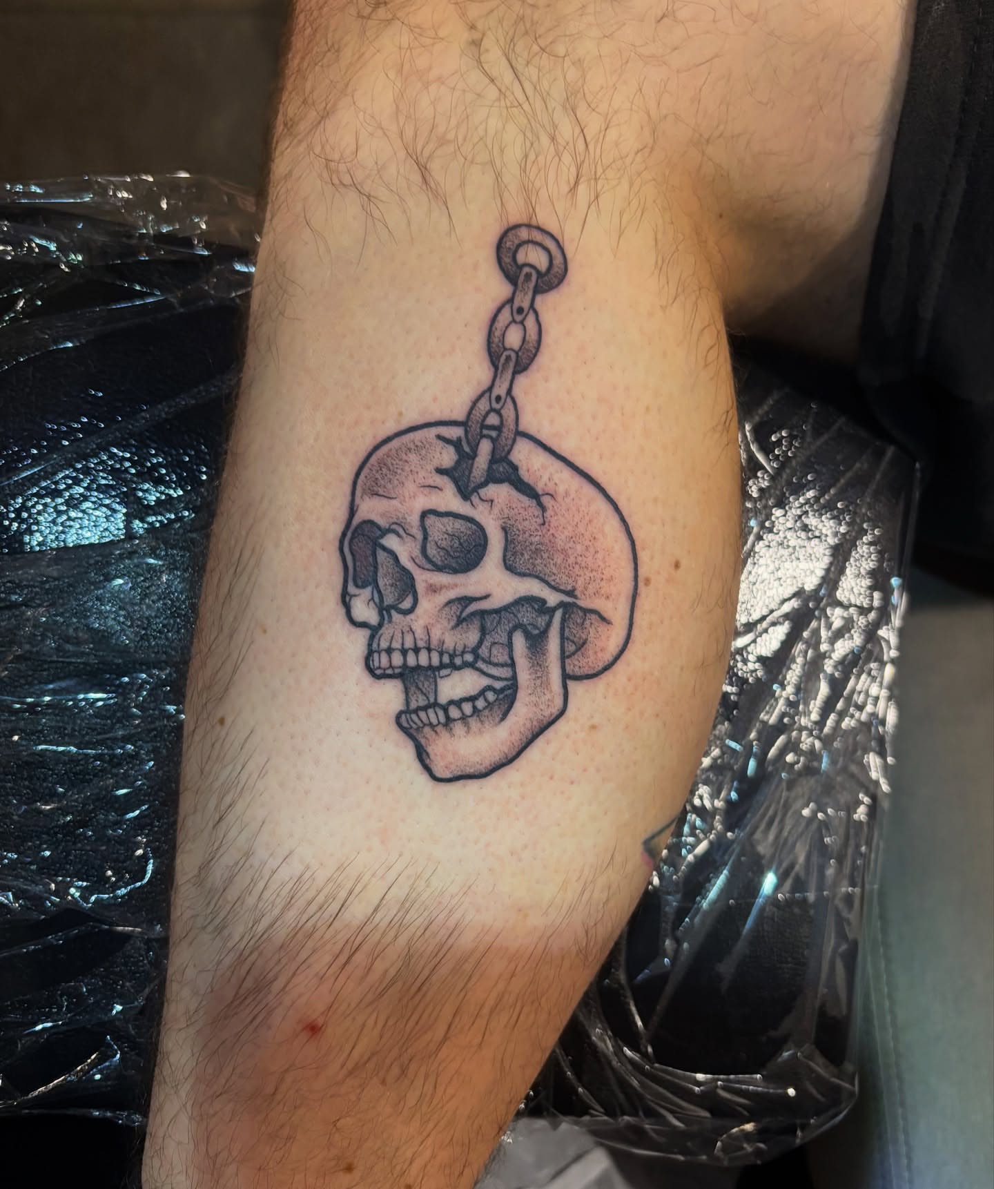 Skull black and grey tattoo on the forearm by Dyllan Shipley