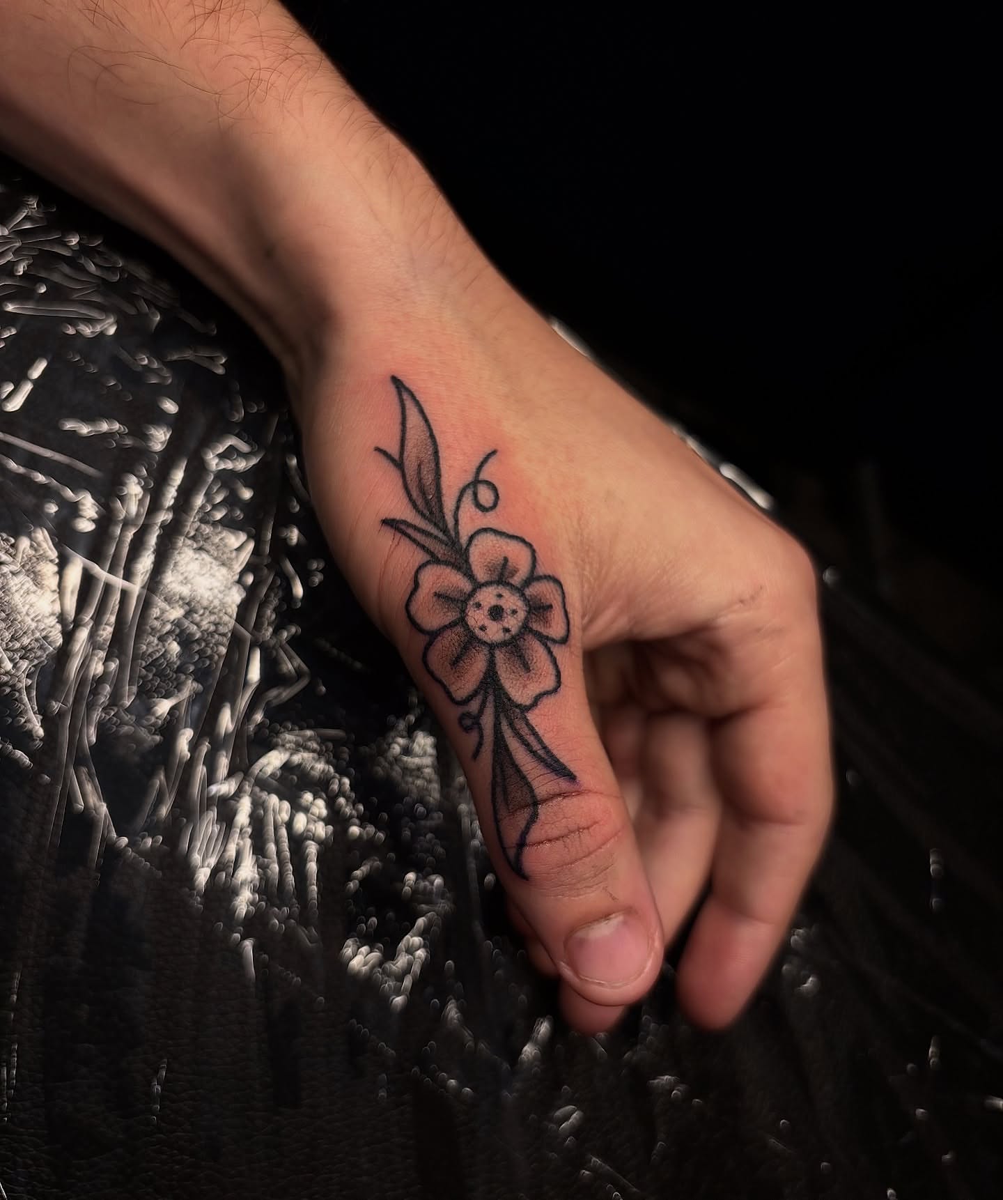 Flower black and grey tattoo on the hand by Dyllan Shipley