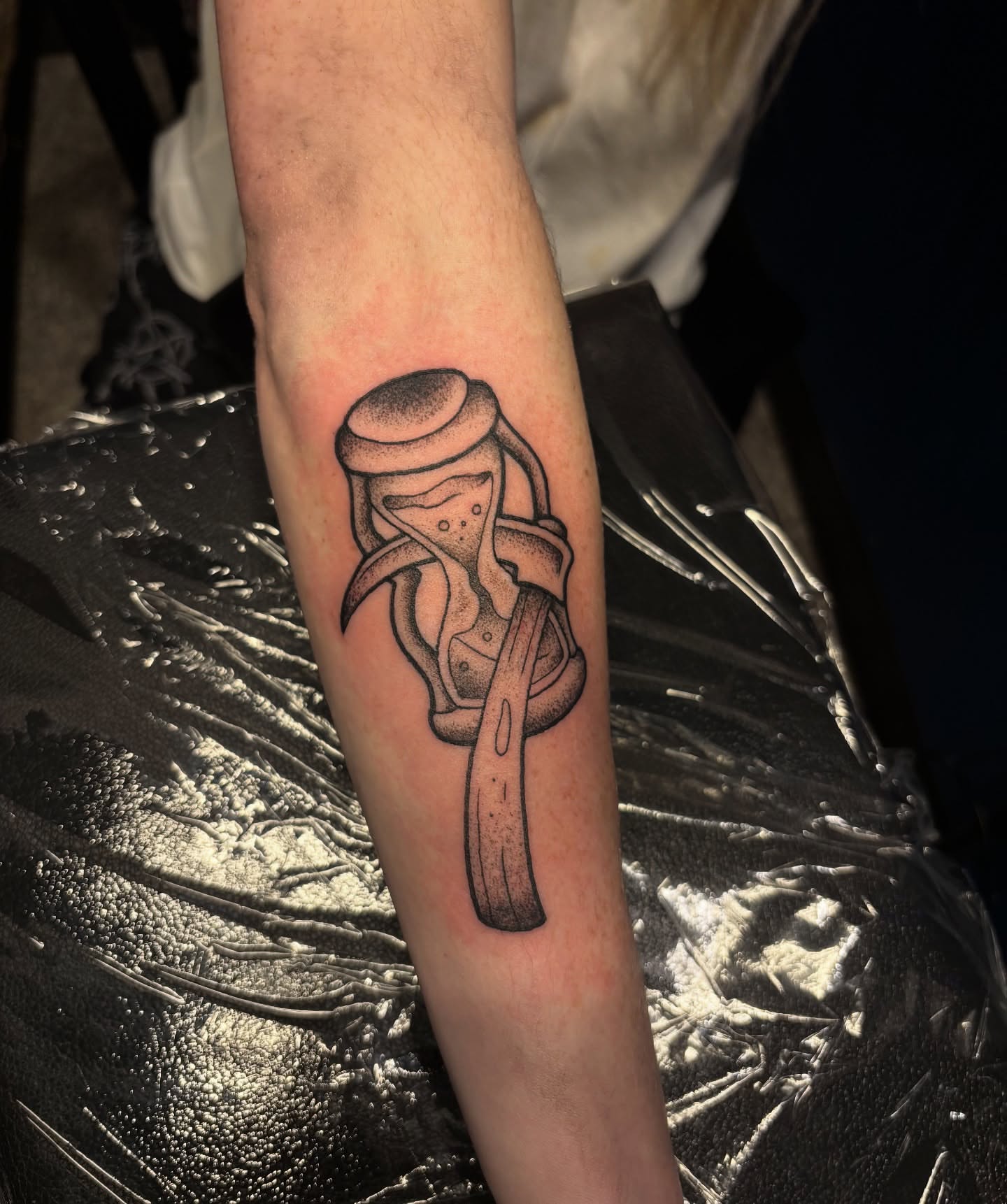 Hourglass dotwork tattoo on the forearm by Dyllan Shipley