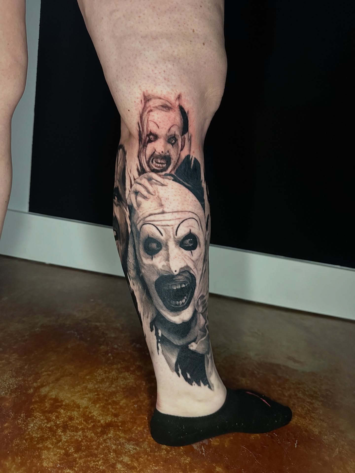 Clowns realism tattoo on the calf by Trent Hebert