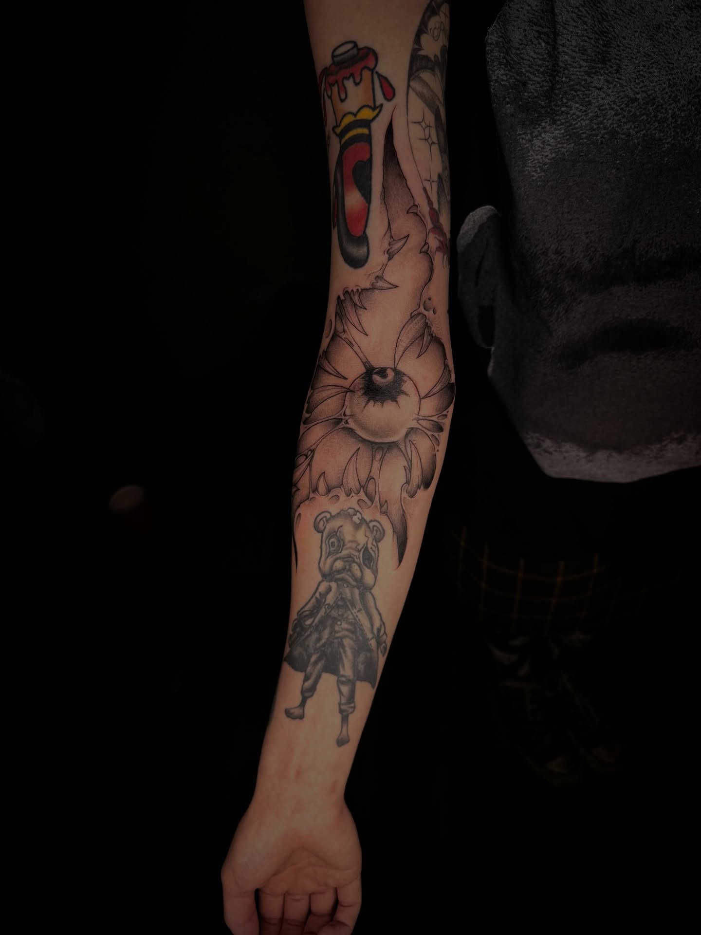 Sunflower and bear black and grey tattoo on the forearm by Marcus
