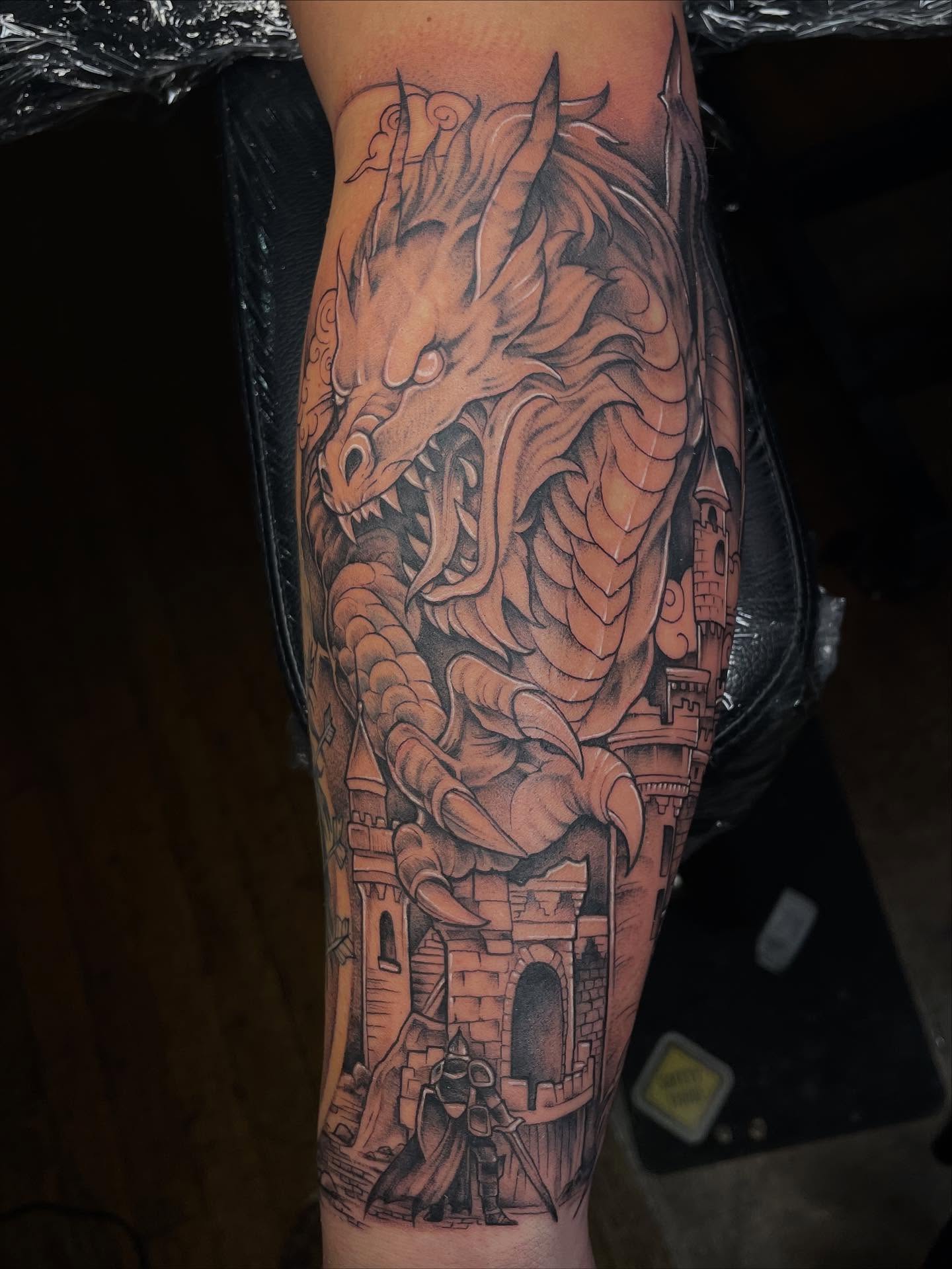 Dragon and castle realism tattoo on the forearm by Lauren Sisouphanh, Canton, Ohio