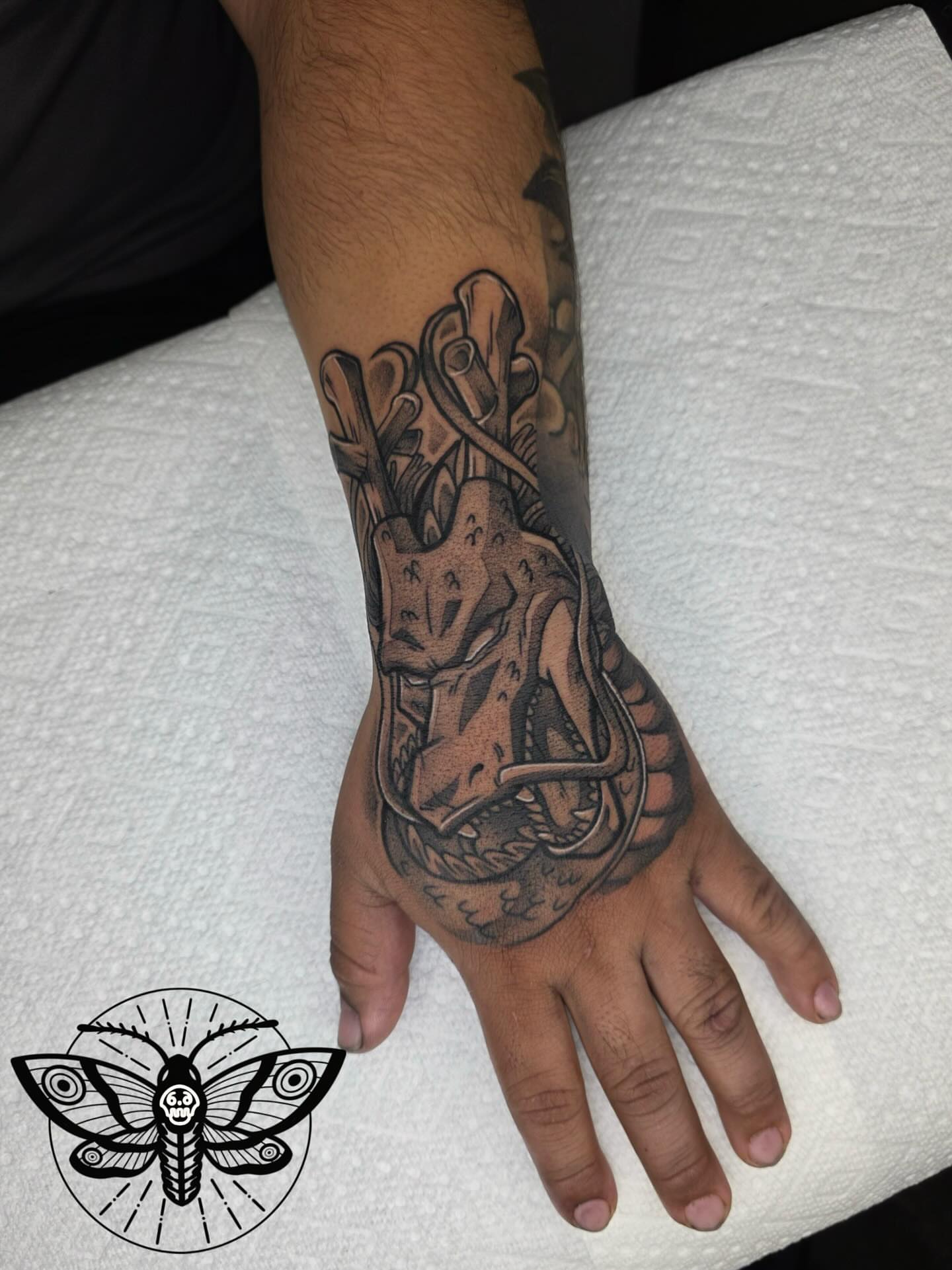 Mask and snake realism tattoo on the hand by Danny, San Luis Obispo, California