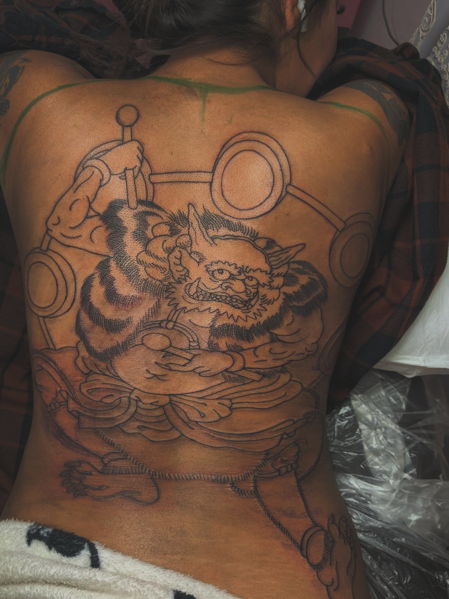 Cat-like creature japanese irezumi tattoo on the back by Angela Mukai