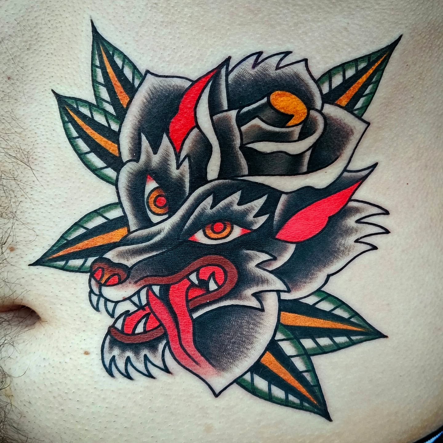 Wolf and rose American traditional tattoo on the torso by Mike Graske, Minneapolis, Minnesota