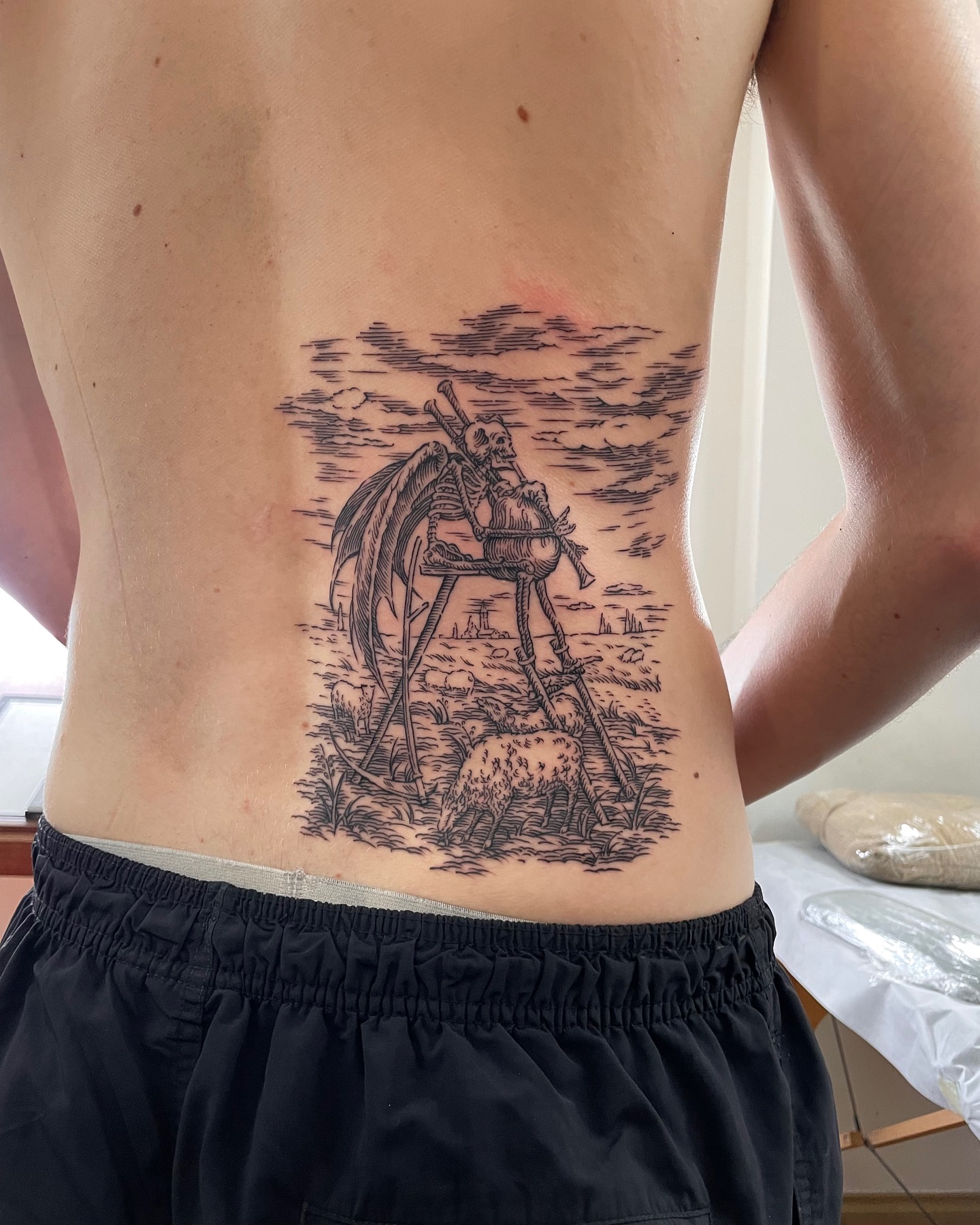 Skeleton with scythe realism tattoo on the back by Anh Đan