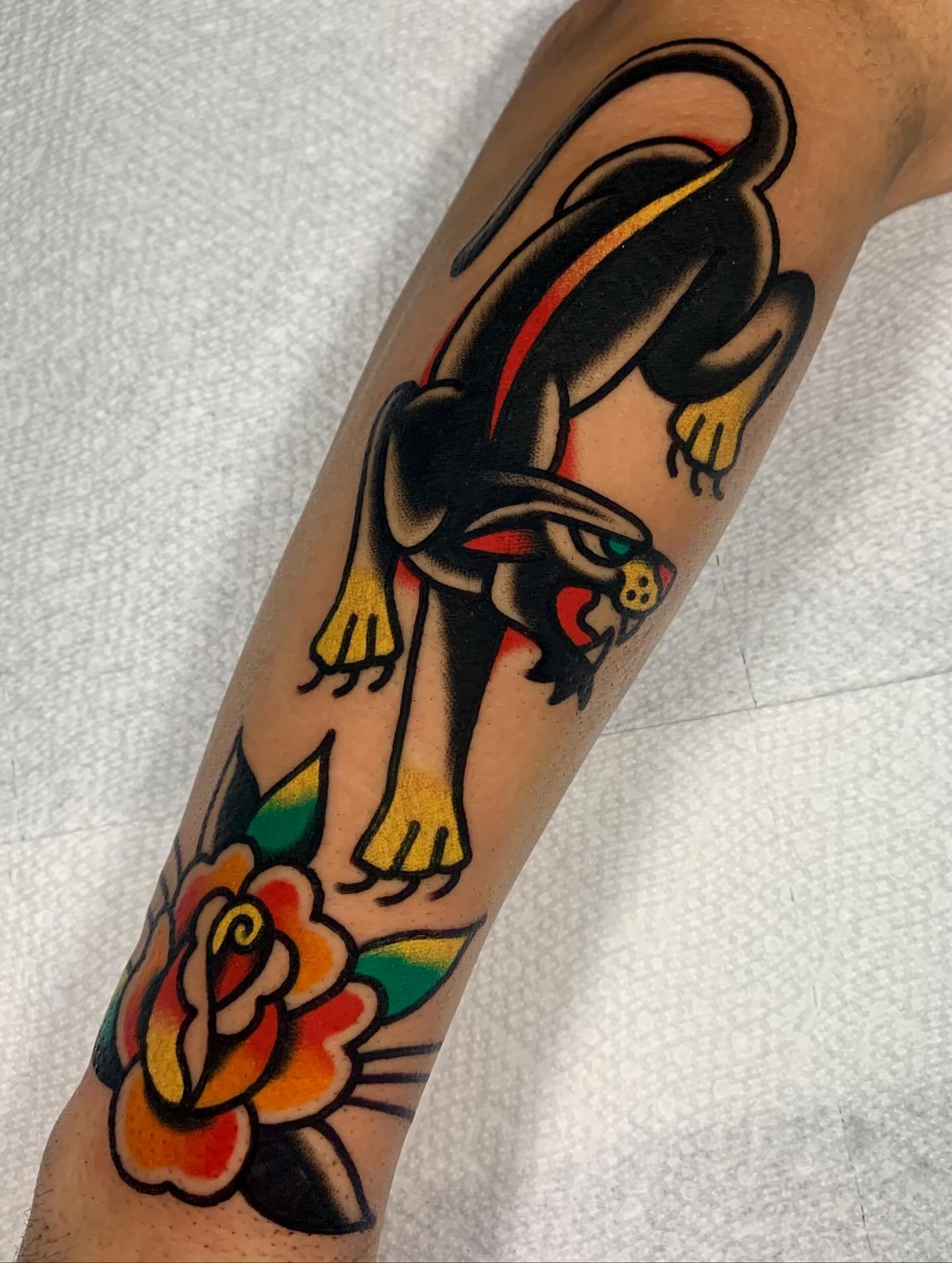 Cat chasing mouse American traditional tattoo on the forearm by Shawn VanKirk