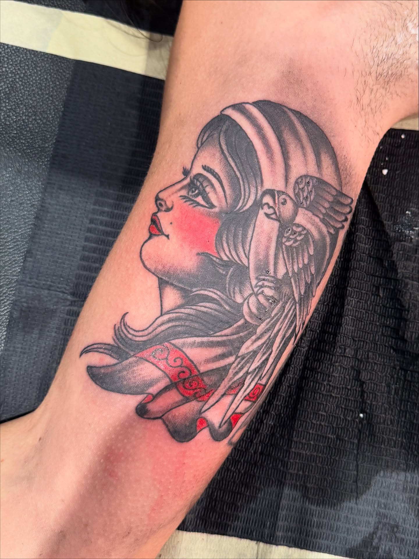 Woman with bird American traditional tattoo on the forearm by Angus Perfect, Philadelphia, Pennsylvania