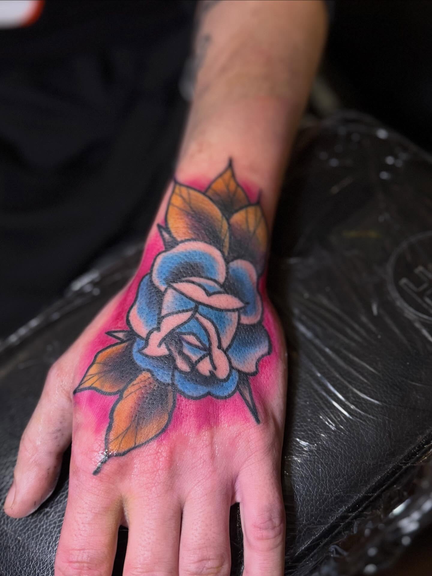 Blue rose American traditional tattoo on the hand by Robbie Roberson
