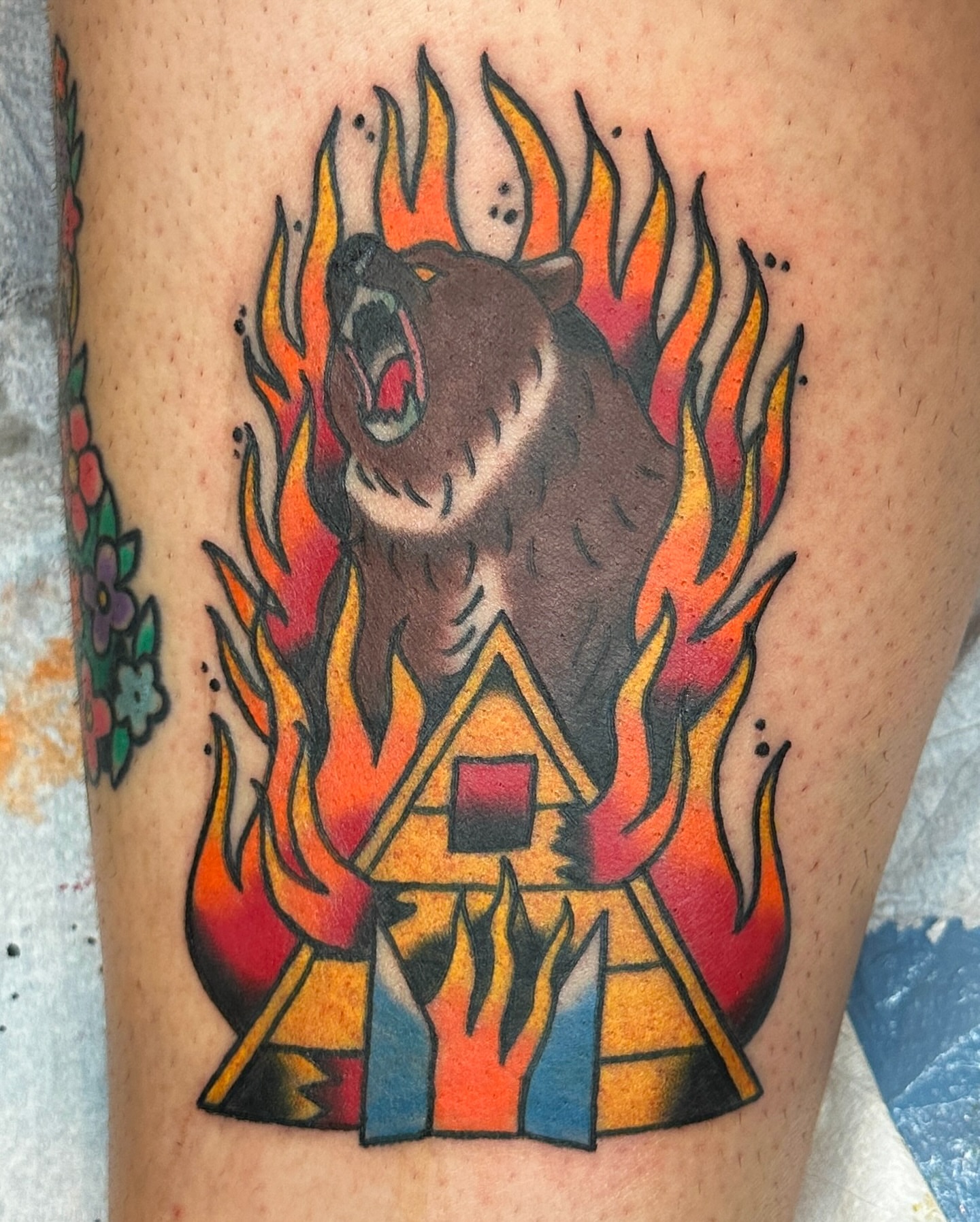 Bear and flames American traditional tattoo on the thigh by Paige Ochoa