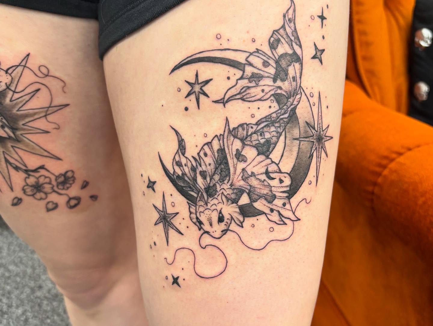 Dragon and crescent moon dotwork tattoo on the thigh by Jayda Shell