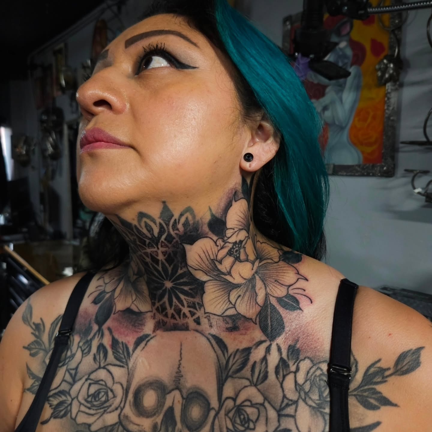 Floral skull realism tattoo on the neck by German Romero-Rendon