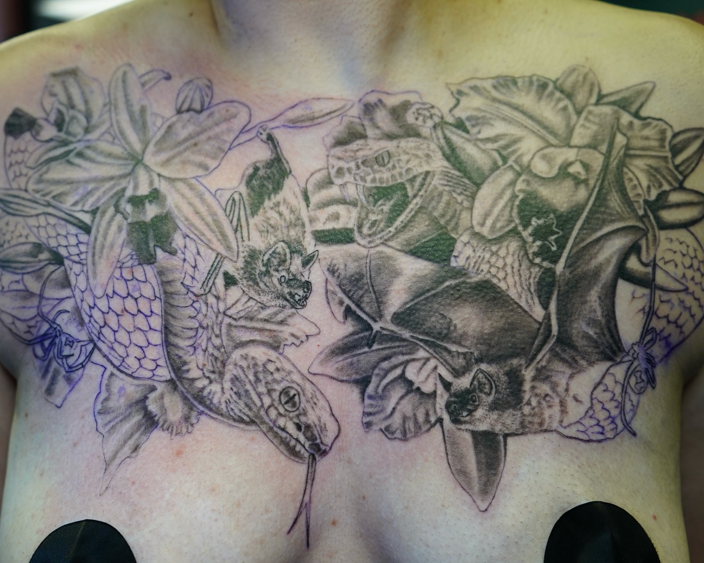 Fish and bat black and grey tattoo on the chest by Ryan