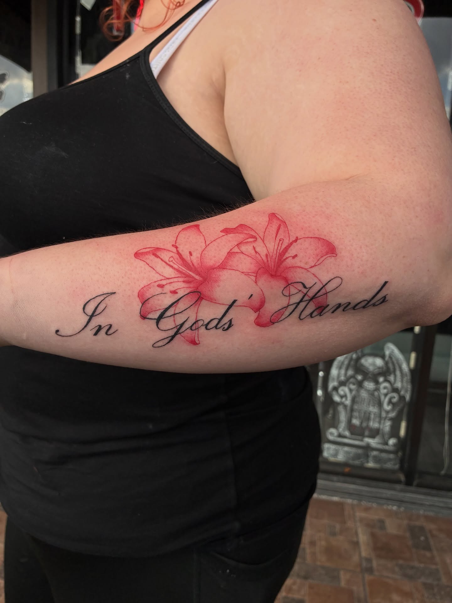 Lilies and script realism tattoo on the forearm by Elijah Cosme, Miami, Florida