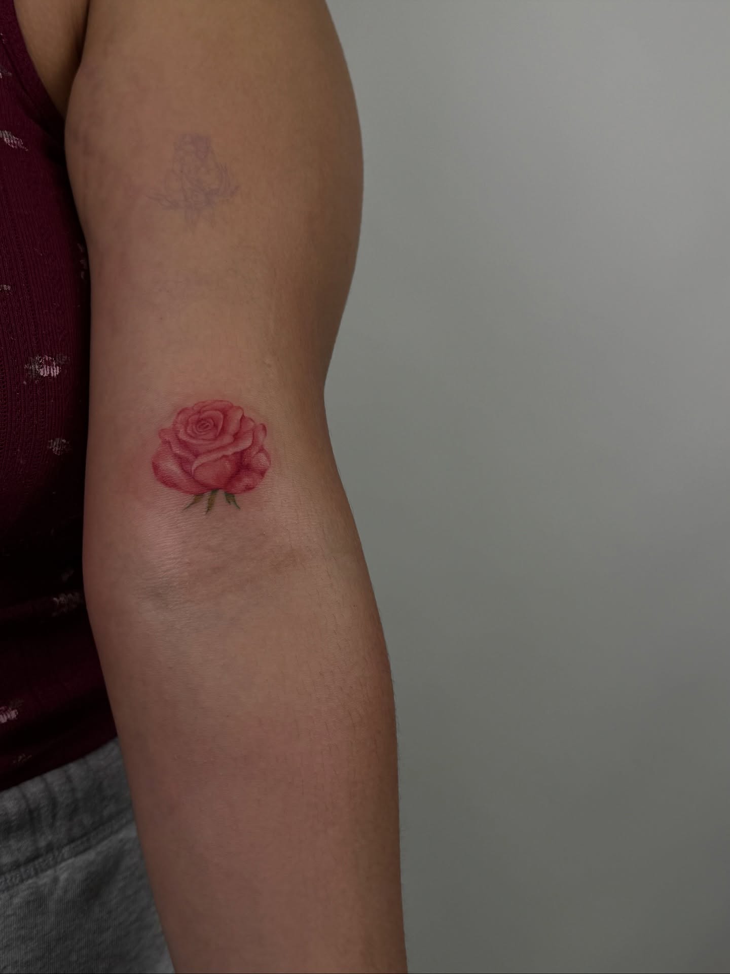 Rose watercolor tattoo on the forearm by sabina