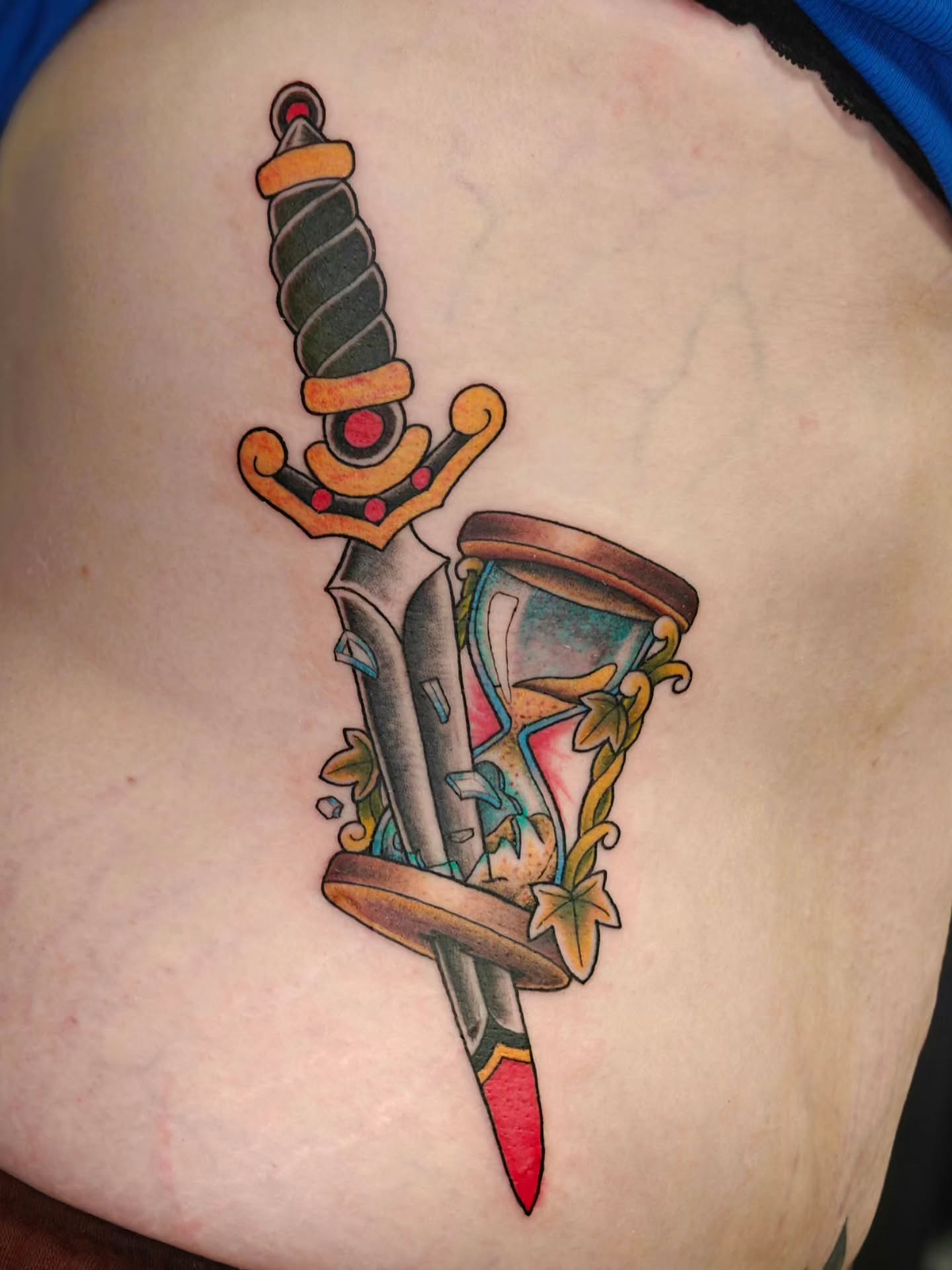 Sword and hourglass American traditional tattoo on the ribs by Tattoos by Reed Blount
