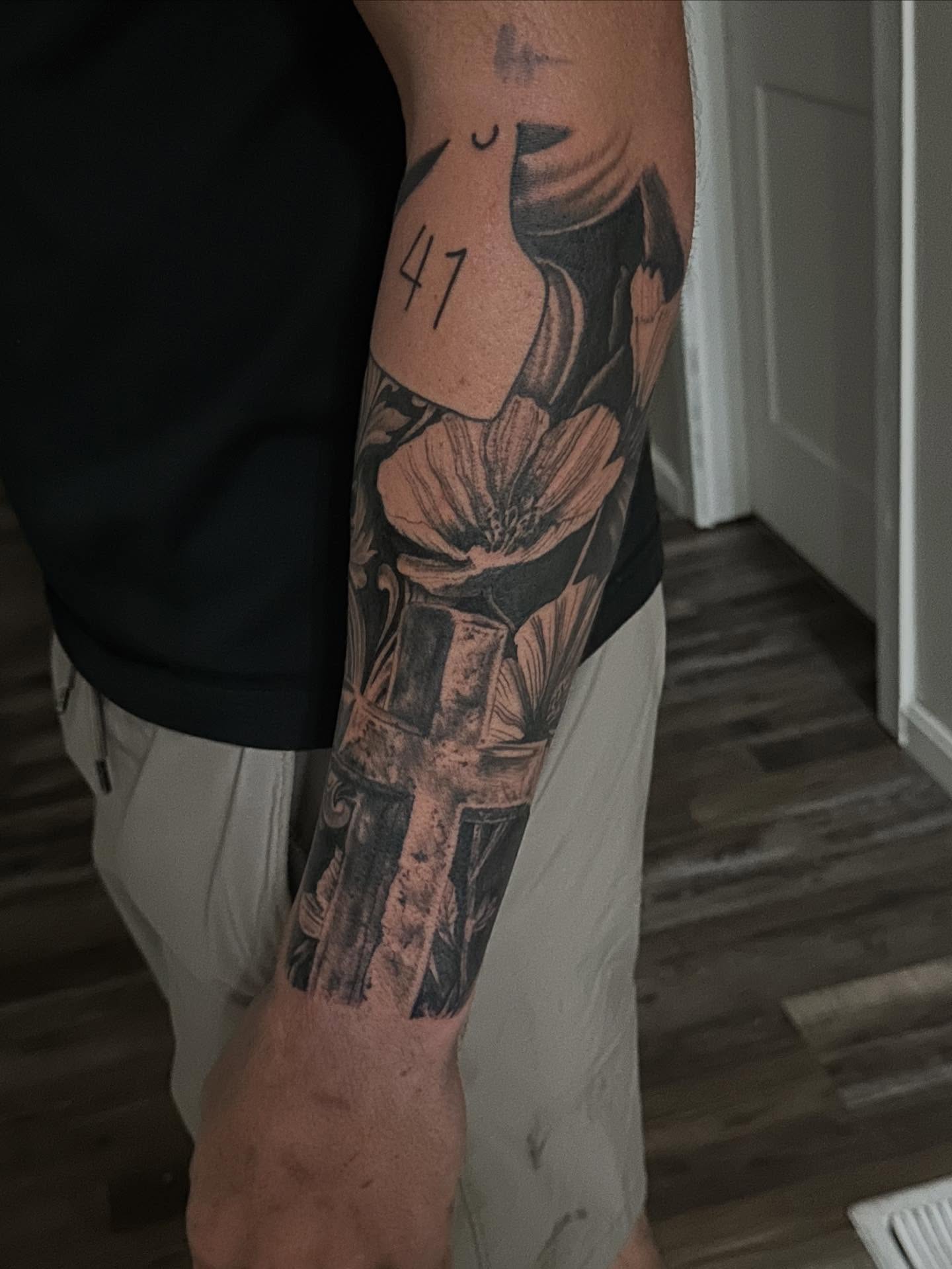 Floral cross realism tattoo on the forearm by Neil5one3