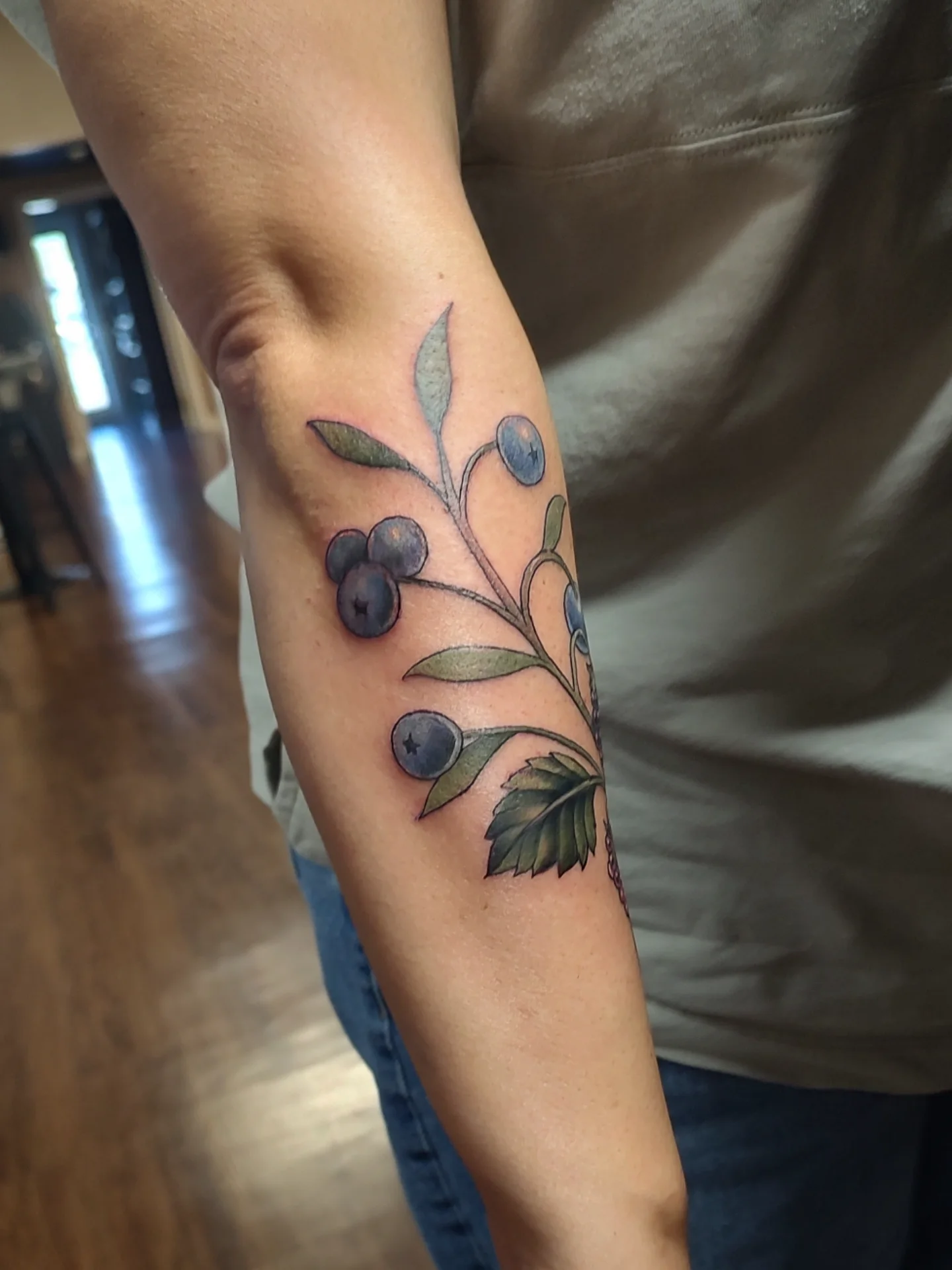 Blueberry plant realism tattoo on the forearm by Jennifer Fowler