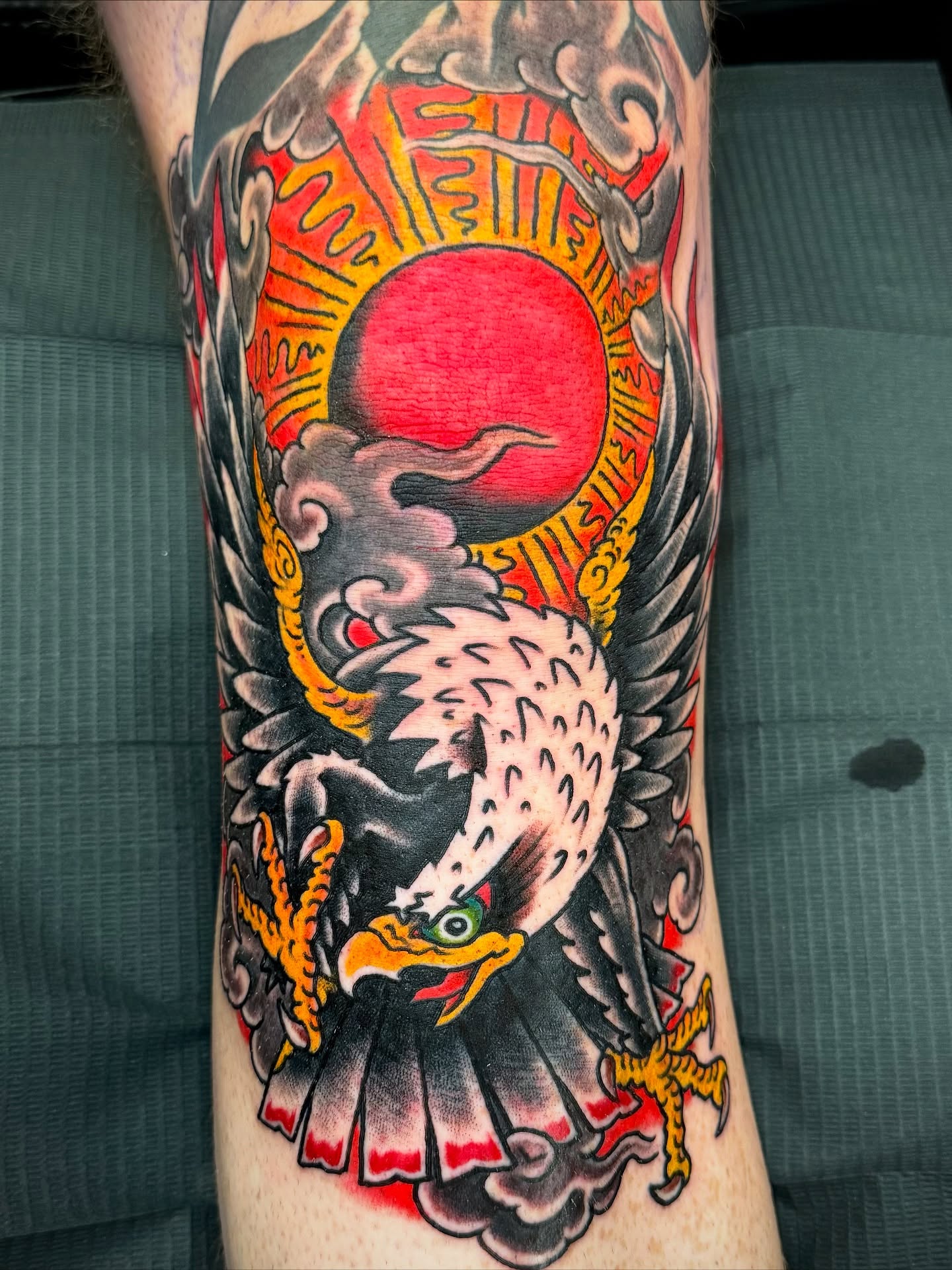 Eagle and sun American traditional tattoo on the forearm by Leif Hansen
