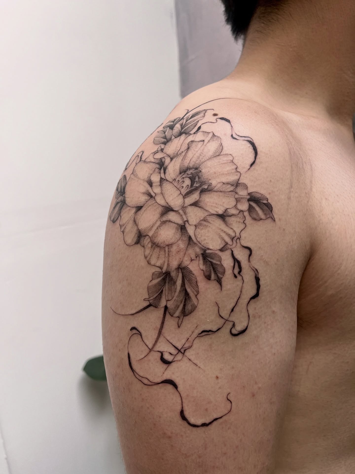 Peony flowers black and grey tattoo on the shoulder by Lo Gwynn
