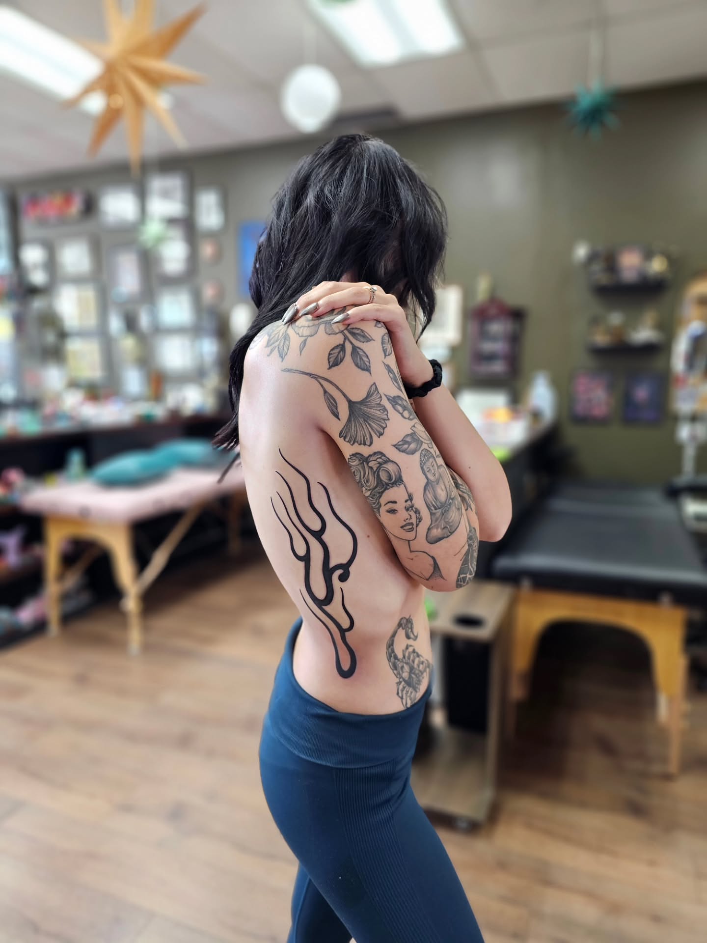 Flame and face black and grey tattoo on the upper arm by Bellz Rehder
