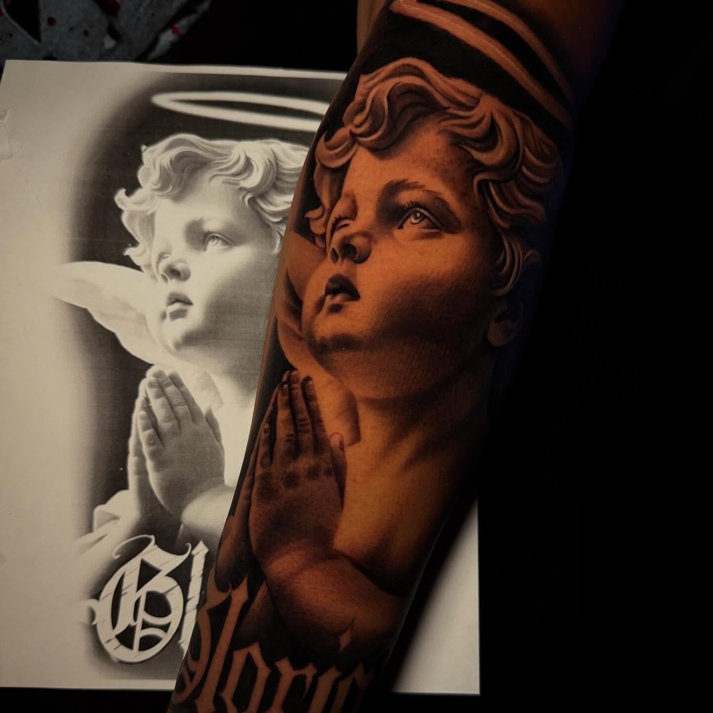 Cherub realism tattoo on the forearm by Jorge Hernandez