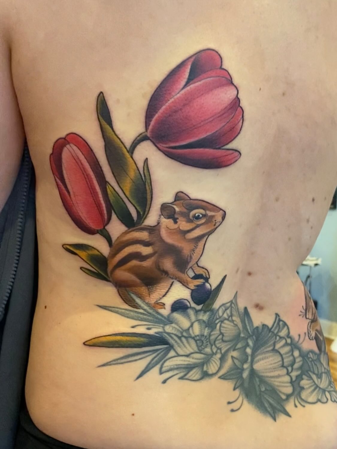 Chipmunk and tulips American traditional tattoo on the ribs by High Vibrations