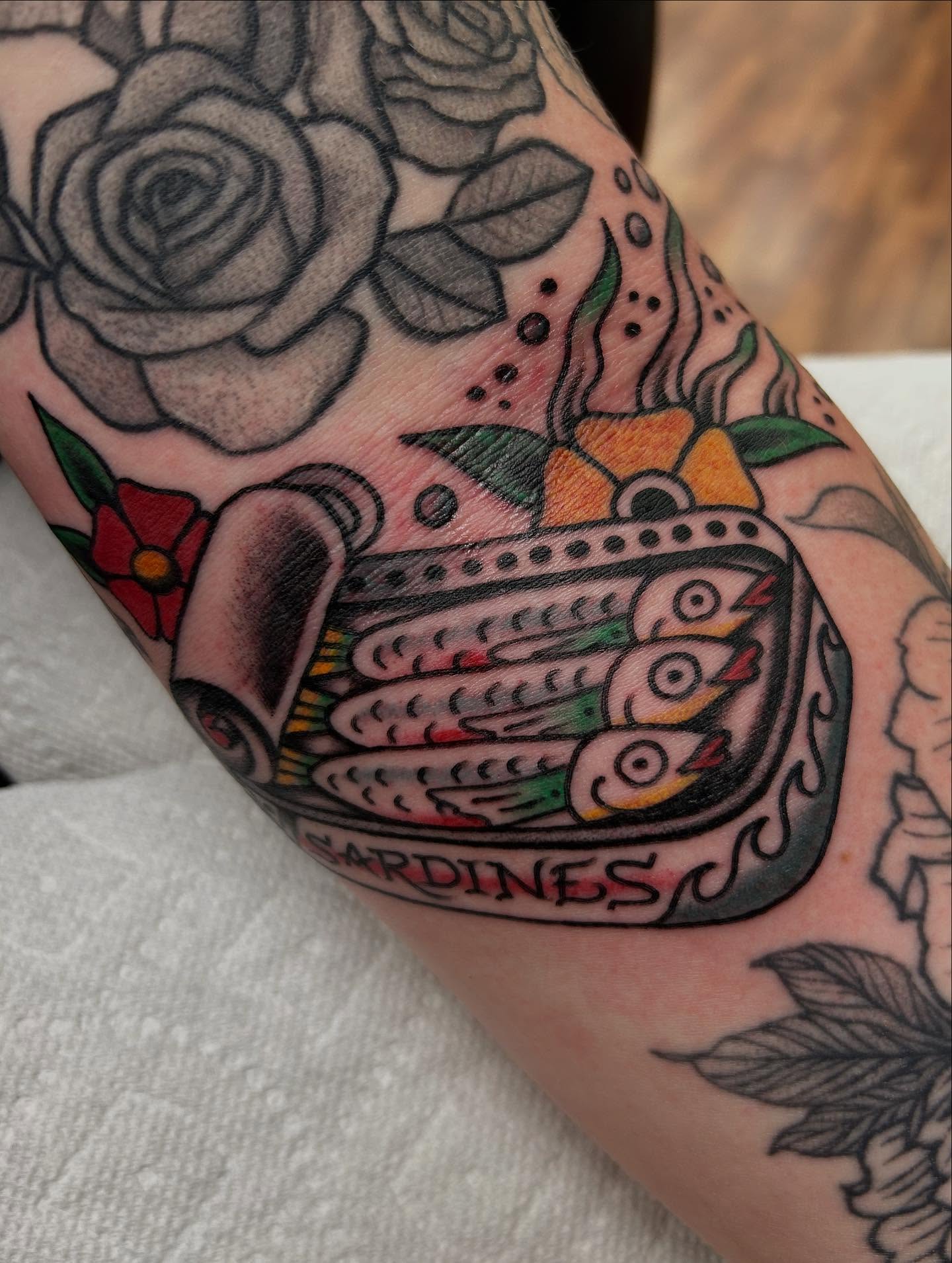 Sardines American traditional tattoo on the forearm by Tiffany Vargas