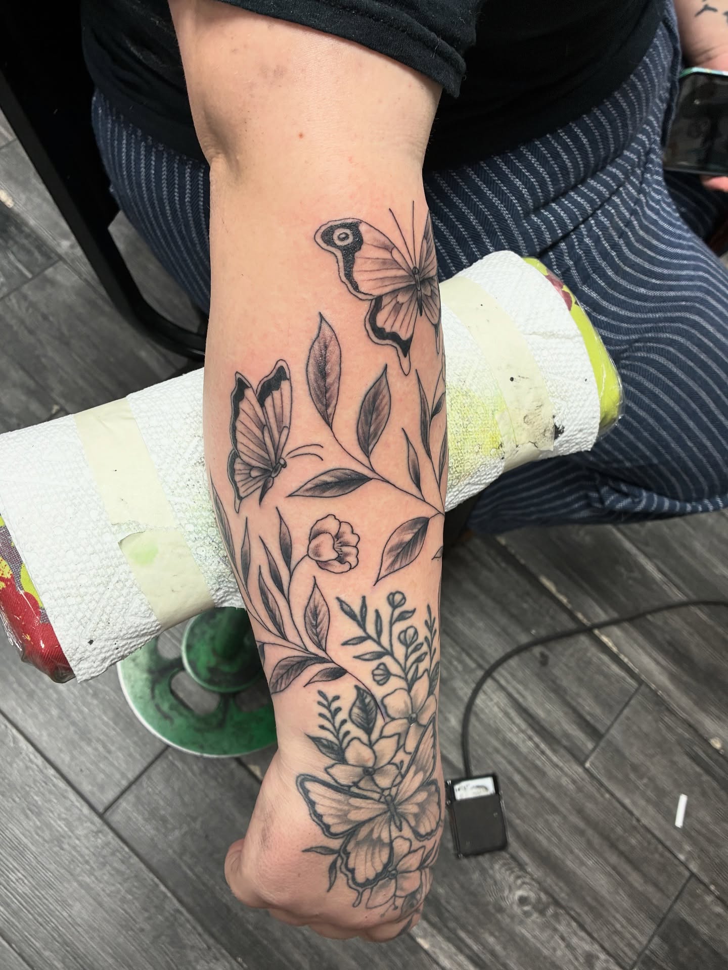 Butterflies and flowers black and grey tattoo on the forearm by Kennedy Cole