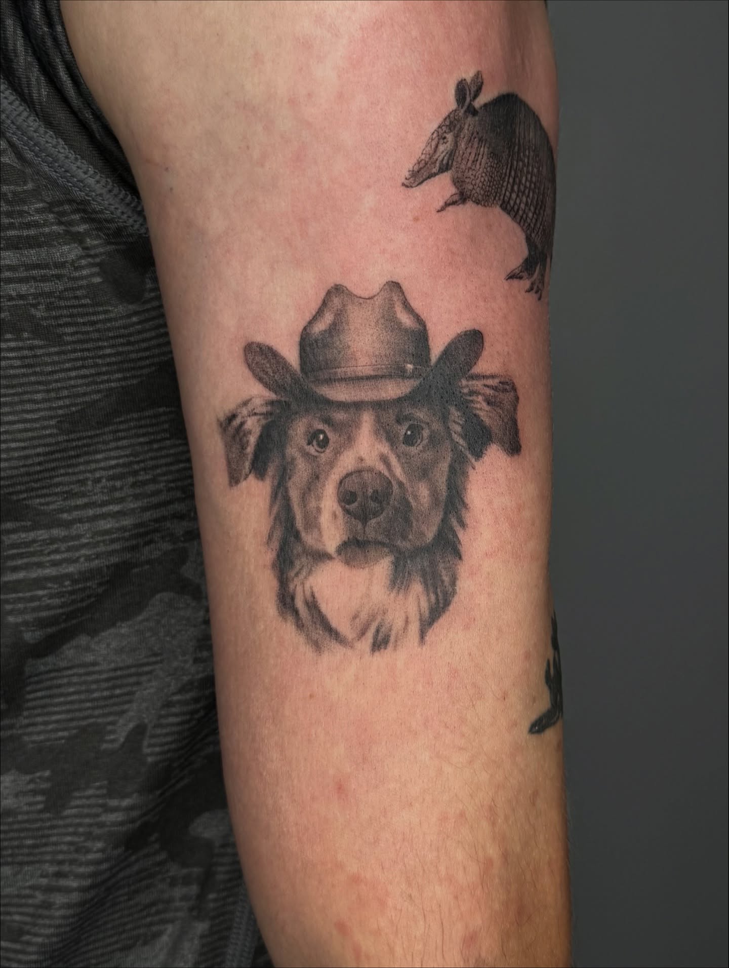 Dog wearing cowboy hat realism tattoo on the forearm by Truett Payton