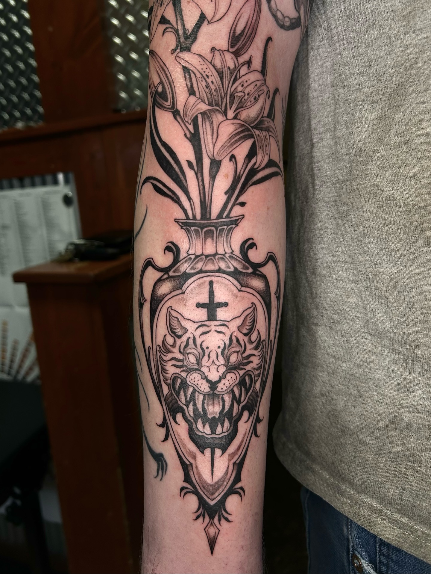 Tiger and lilies realism tattoo on the forearm by Magnus