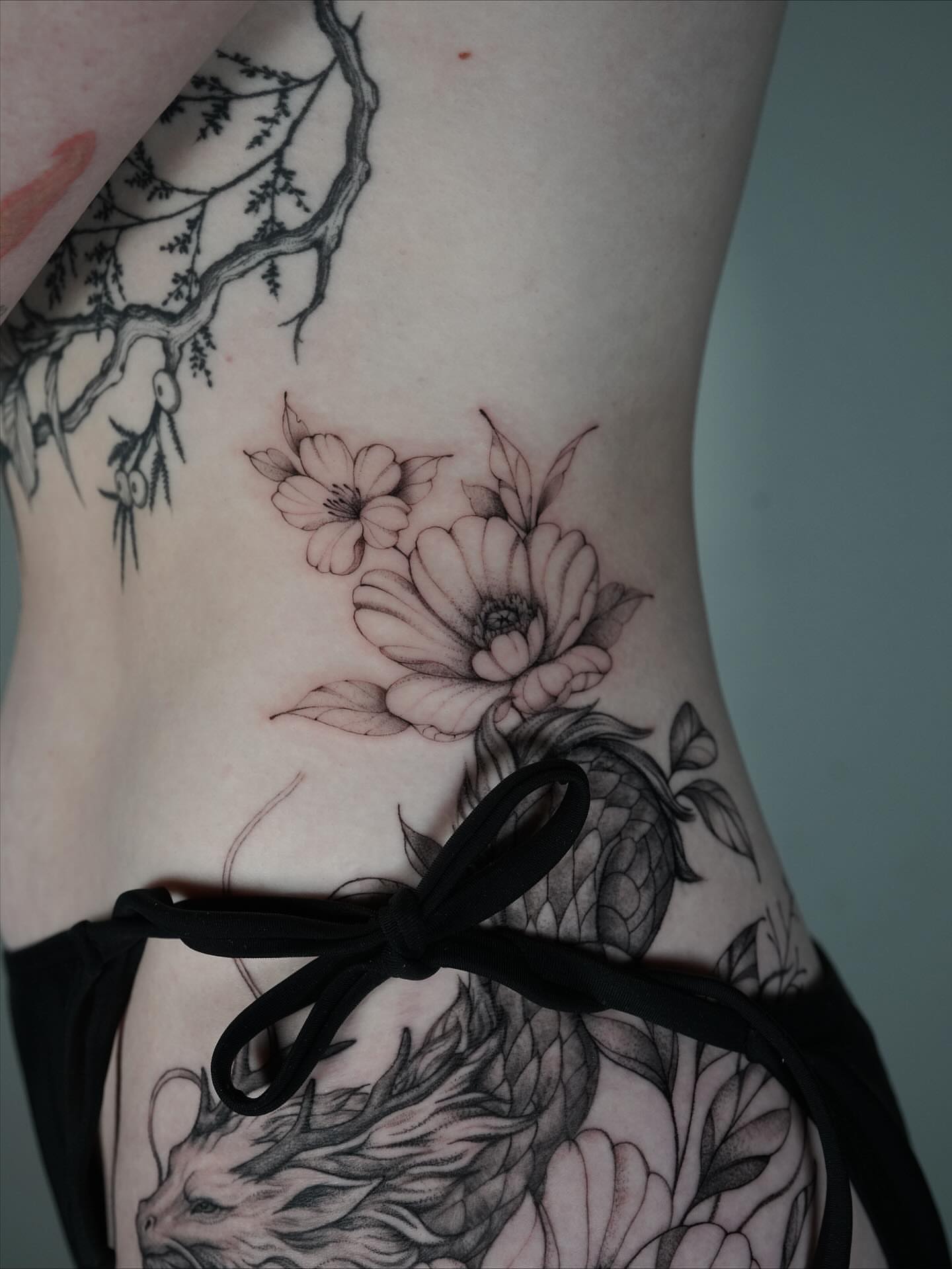 Flowers and dragon realism tattoo on the torso by Tattoo artist LA ། Fine line, Micro realism