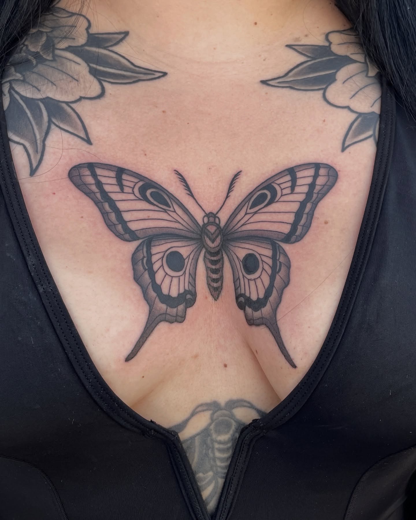 Butterfly black and grey tattoo on the chest by Austin Clark