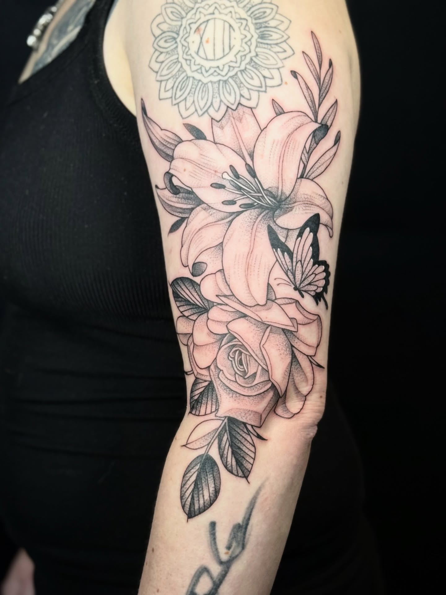 Flowers and butterfly realism tattoo on the forearm by Miles Romero Smith