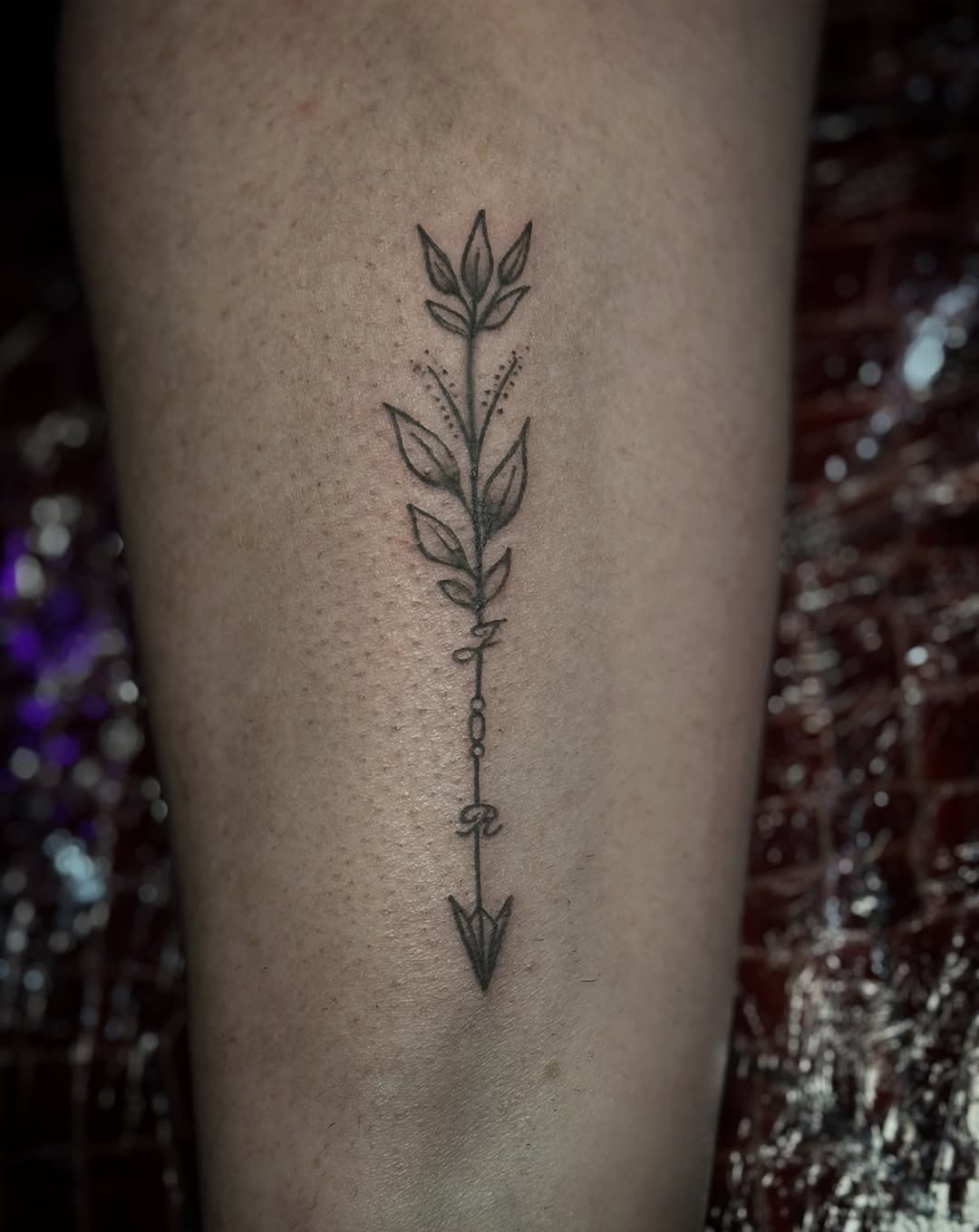 Arrow with leaves and lettering fine line tattoo on the forearm by Juliette :D