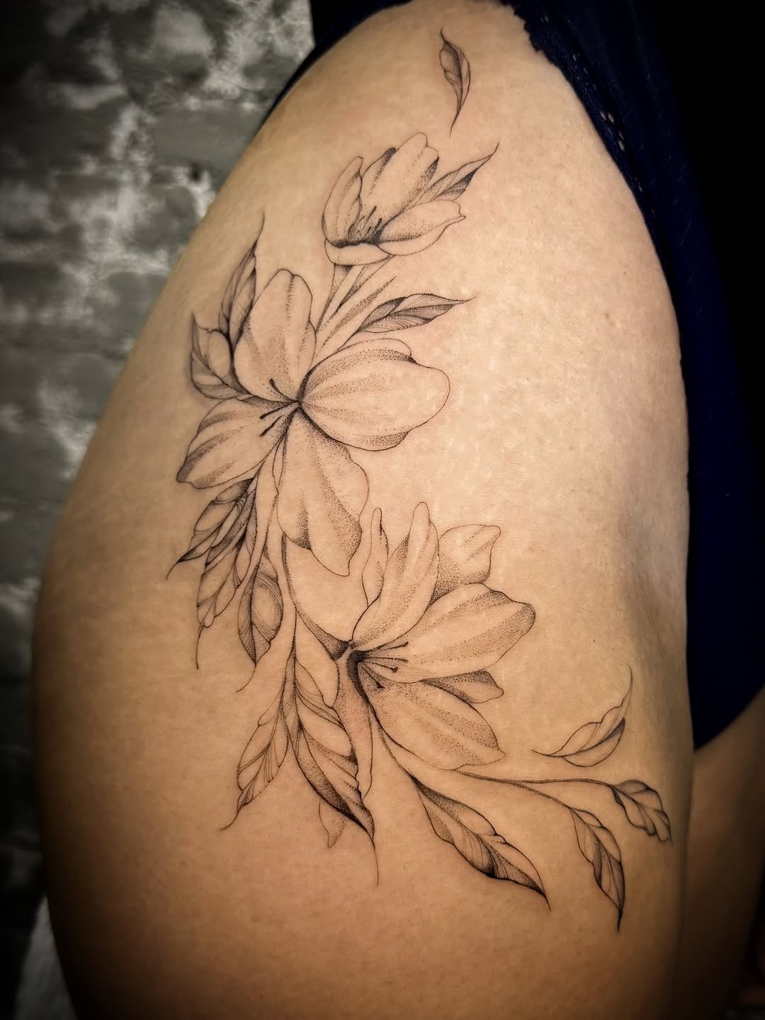Flowers and leaves fine line tattoo on the shoulder by Nyc Tattoo Manhattan