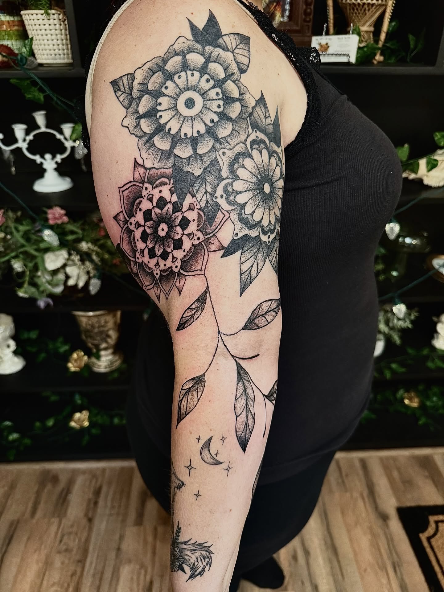 Floral arrangement dotwork tattoo on the forearm by Haley Bates
