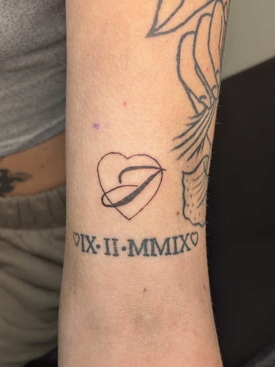 Heart with arrow geometric tattoo on the forearm by Kam