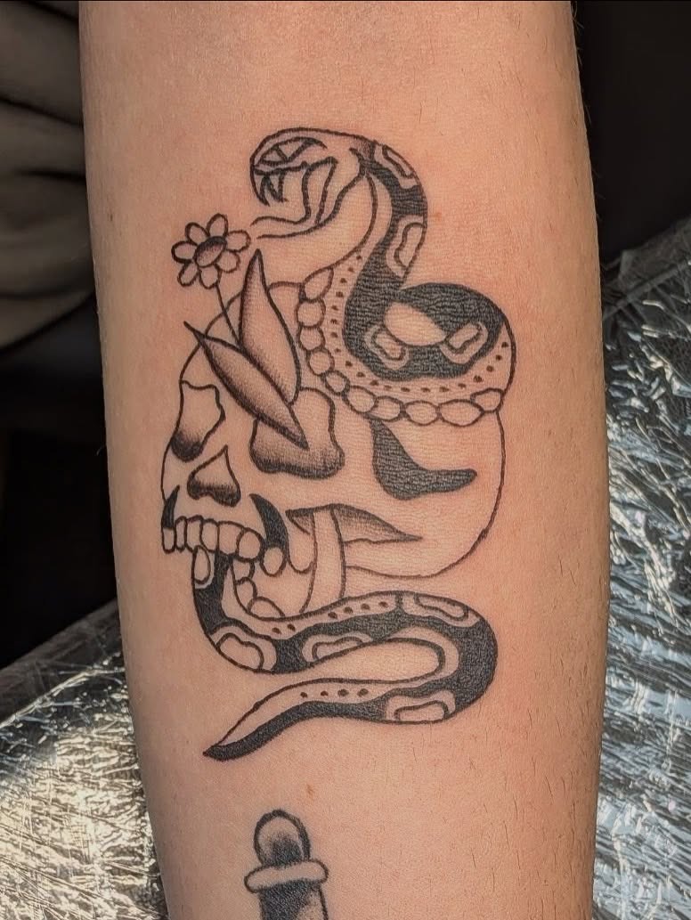 Snake and skull black and grey tattoo on the forearm by Kam