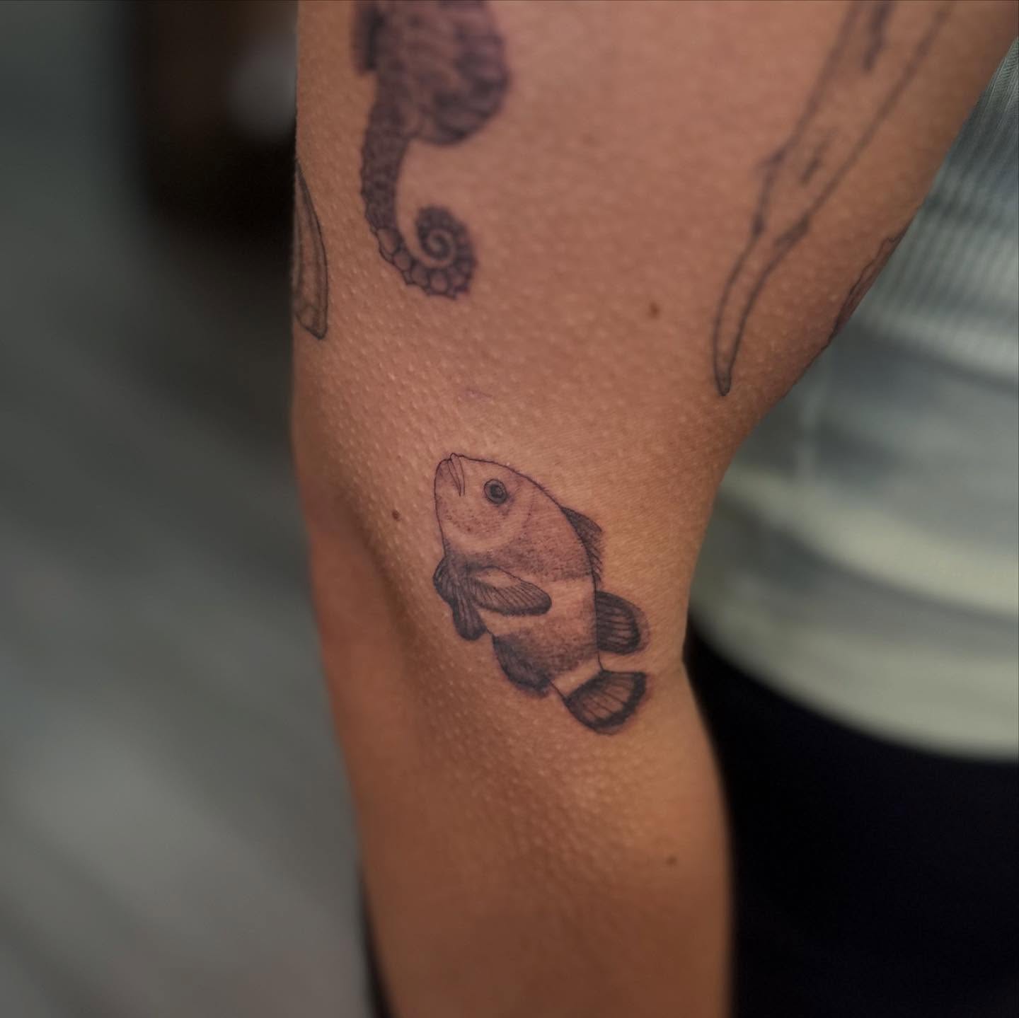 Fish black and grey tattoo on the forearm by Bell